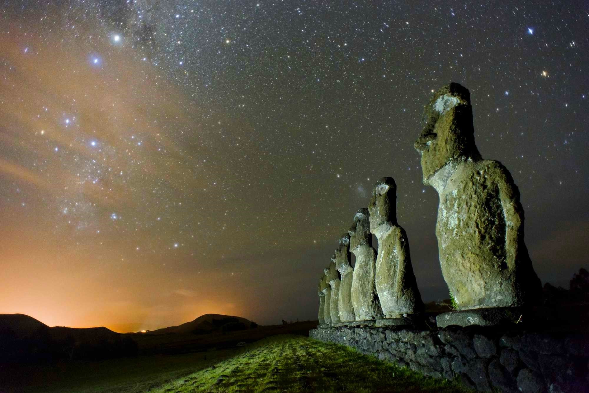 Moai statues under a starry night sky on Easter Island, Chile HD Wallpaper