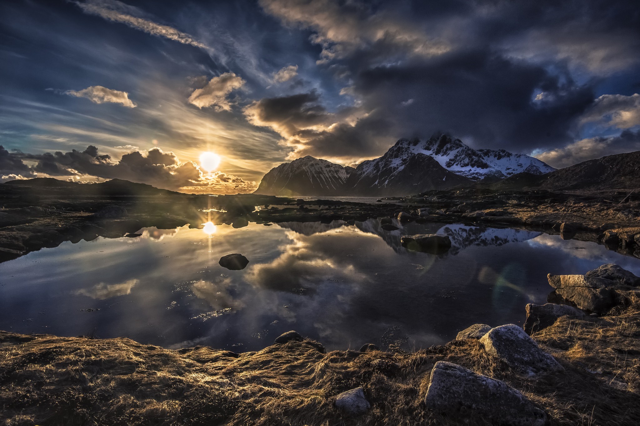 Sunset over snowy mountains and a lake in Lofoten, Norway HD Wallpaper