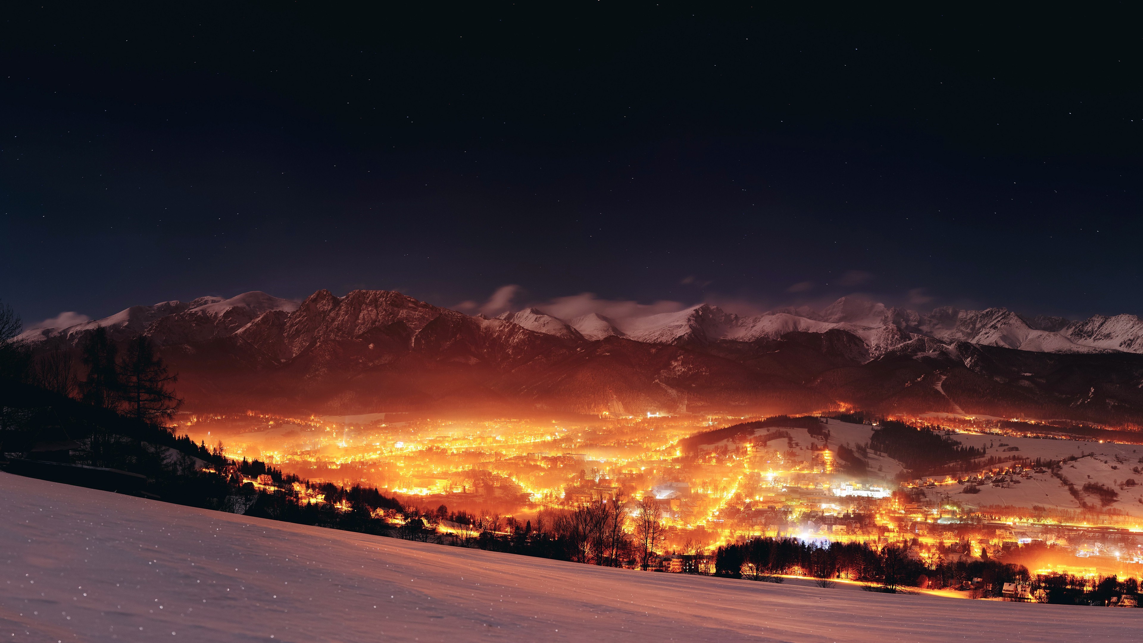 Night landscape of mountains and a glowing town in Poland HD Wallpaper