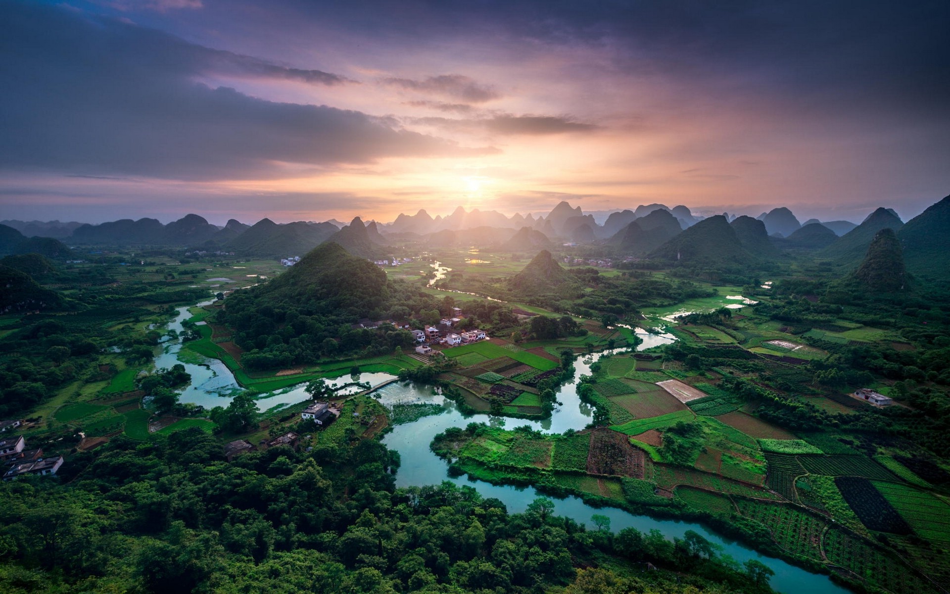 Karst landscape with river and fields at sunset in China HD Wallpaper