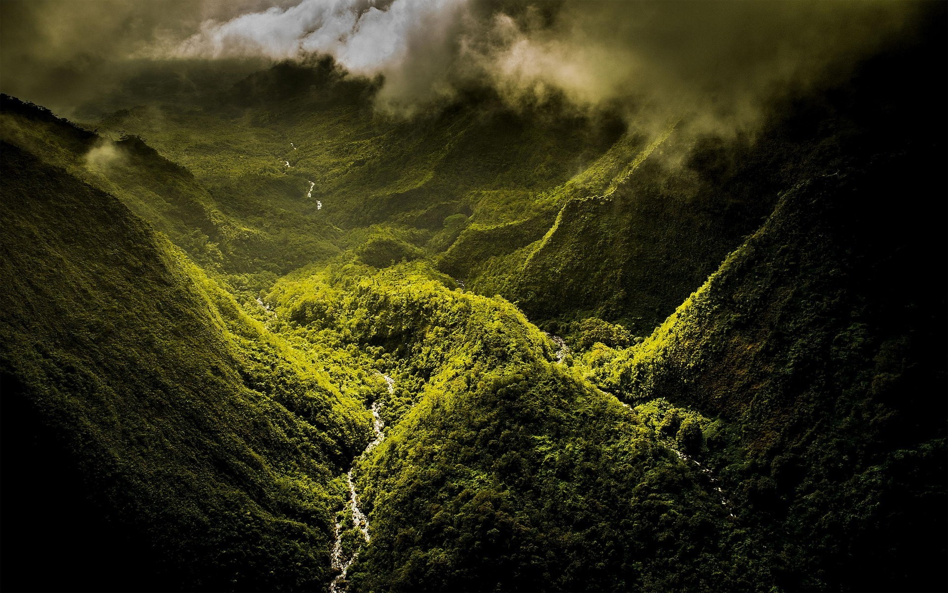 Aerial view of a green mountain valley with a river and clouds HD Wallpaper