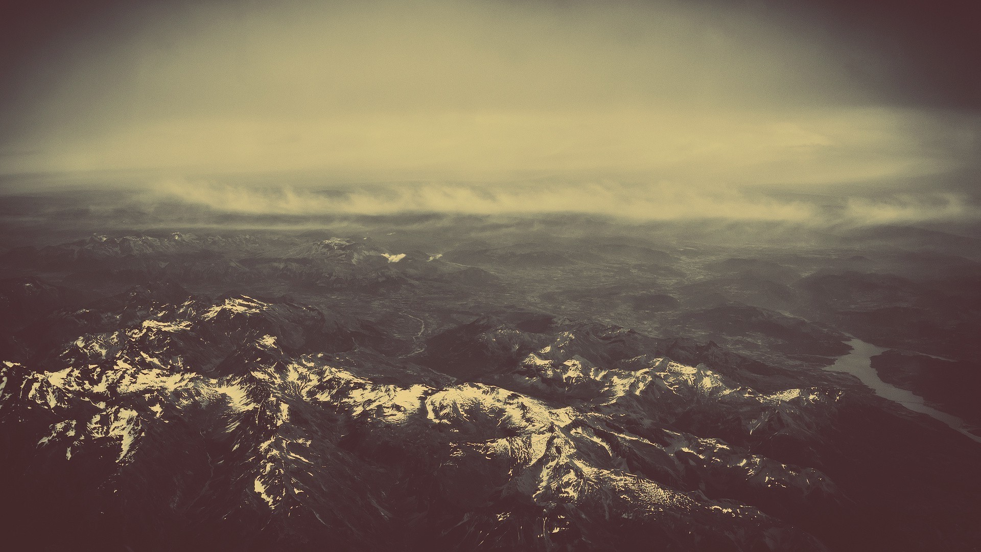 Aerial view of snow-capped mountains and clouds HD Wallpaper