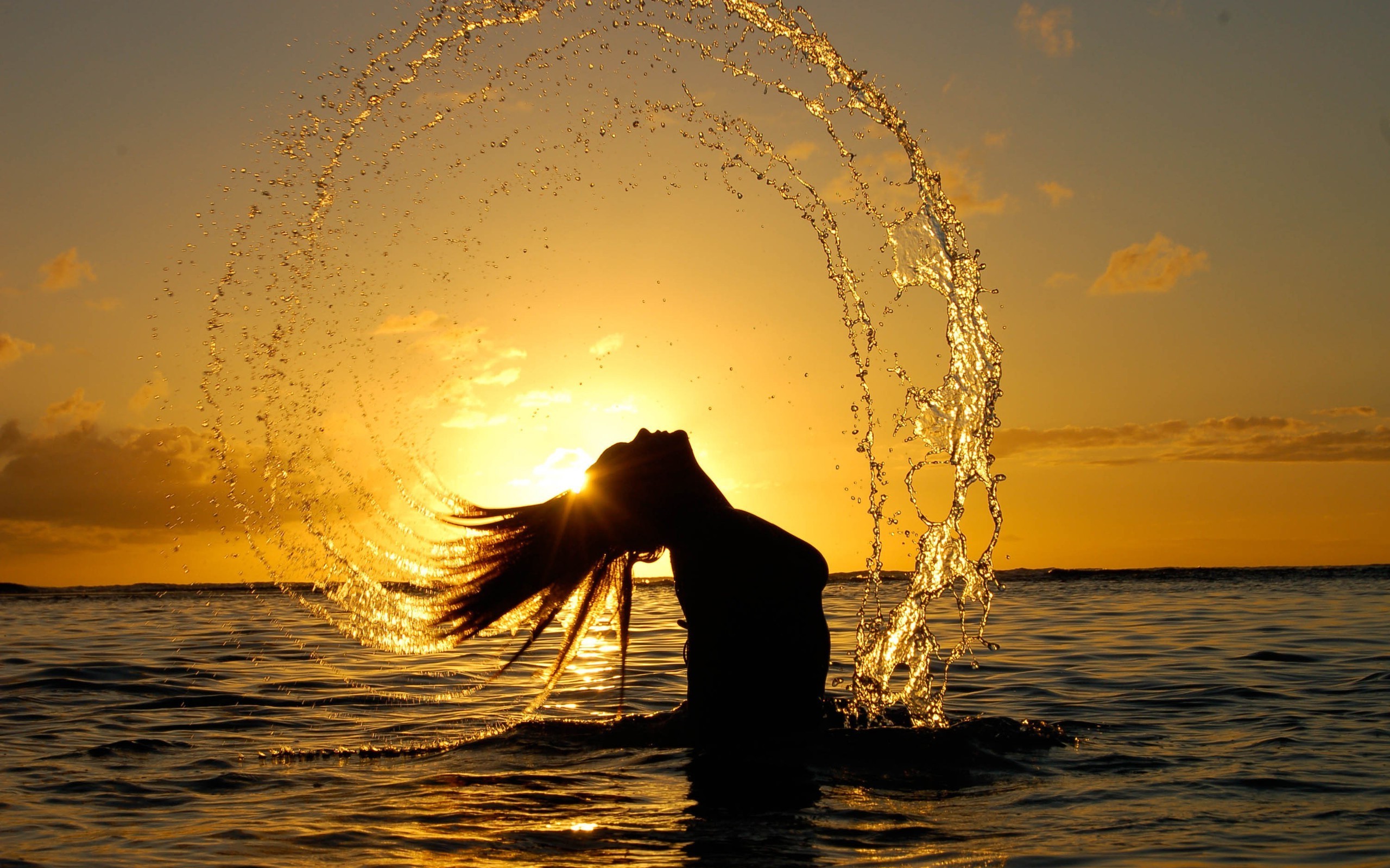 Woman splashing water at sunset HD Wallpaper