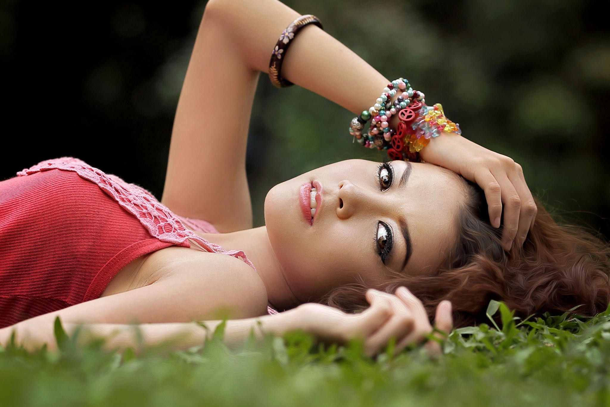 Asian woman with long brown hair lying on grass HD Wallpaper