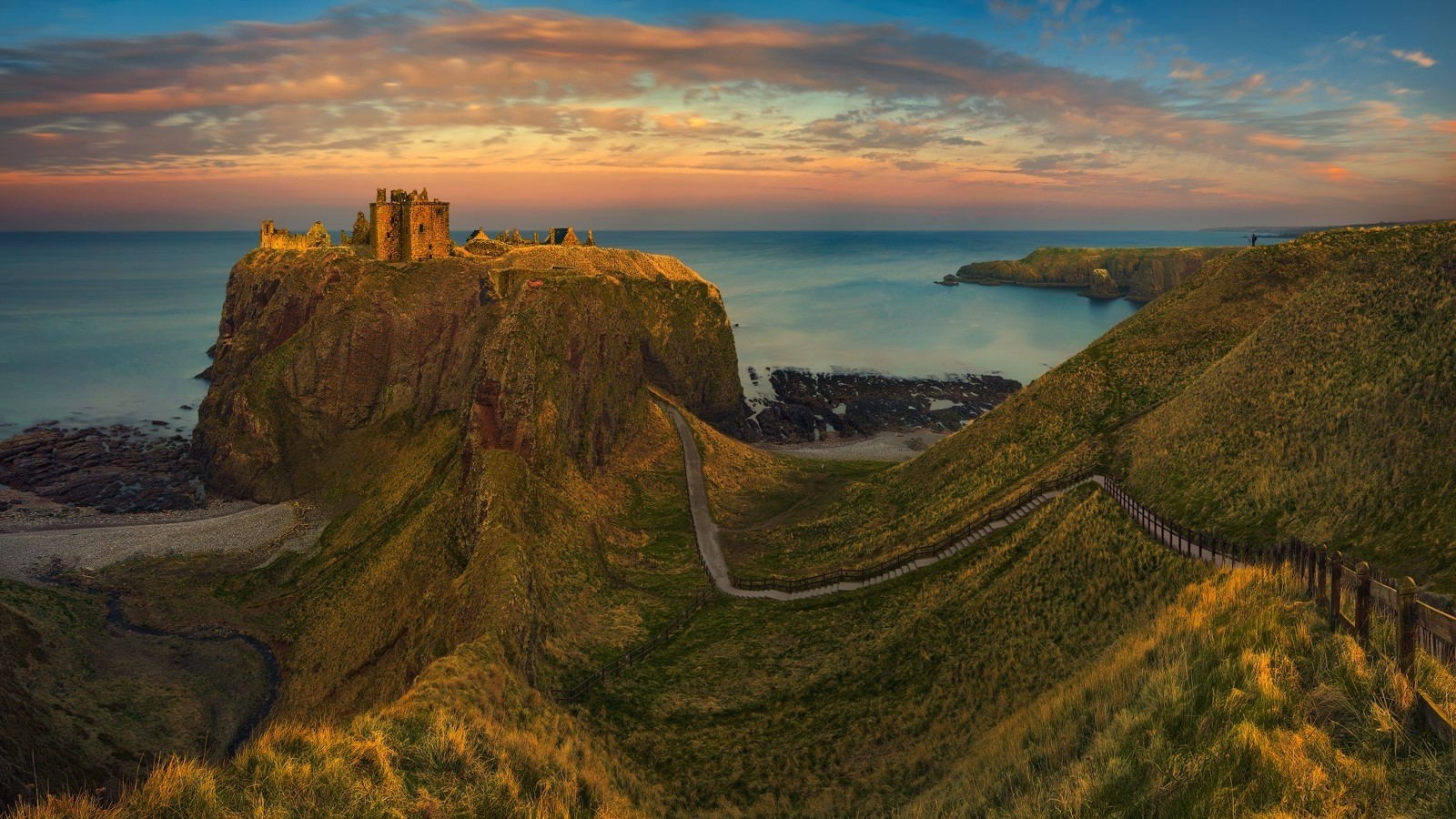 Dunnottar Castle ruins on a cliff overlooking the sea at sunset HD Wallpaper