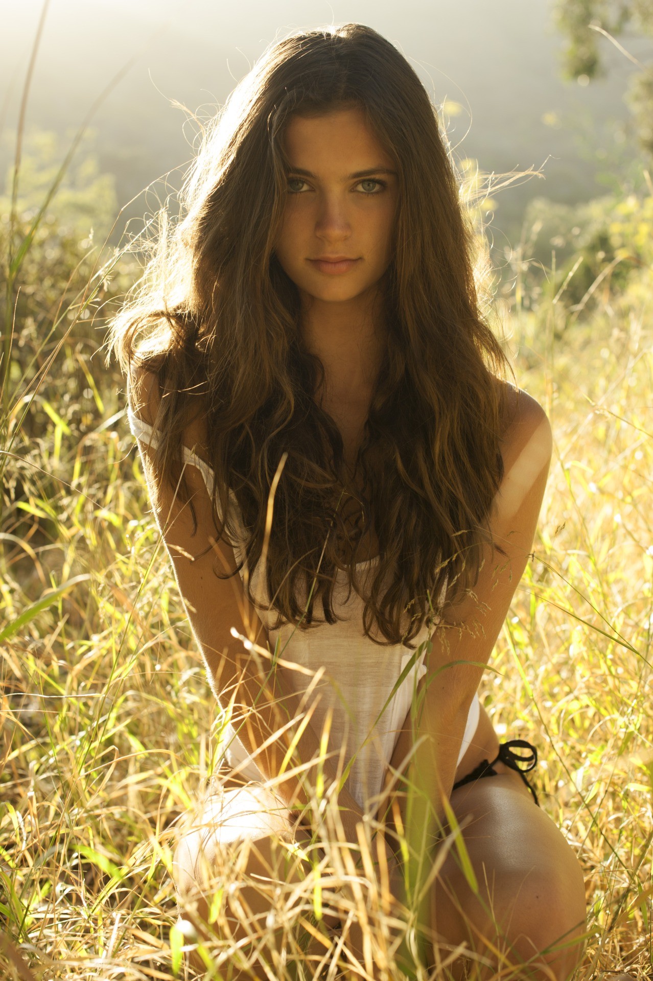 Woman with long brown hair in tall grass HD Wallpaper