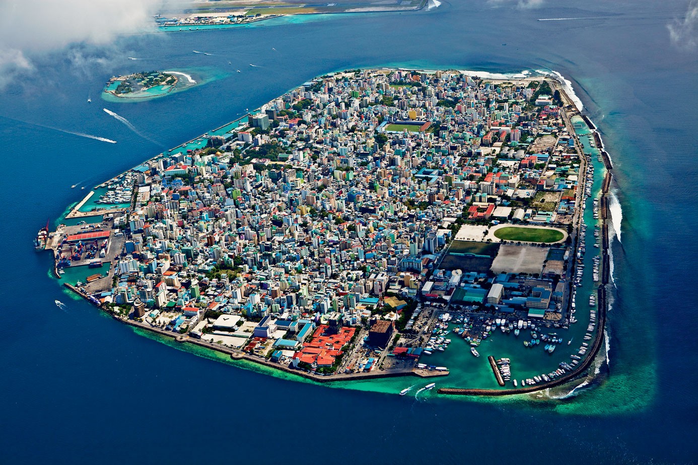 Aerial view of Male, Maldives city island with harbor and boats HD Wallpaper