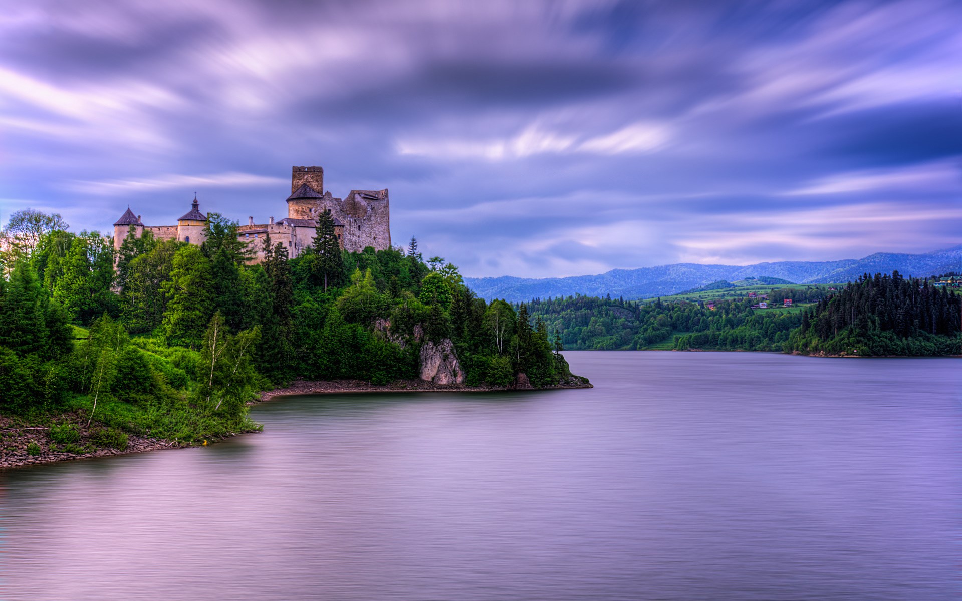 Castle on a hill overlooking a lake HD Wallpaper