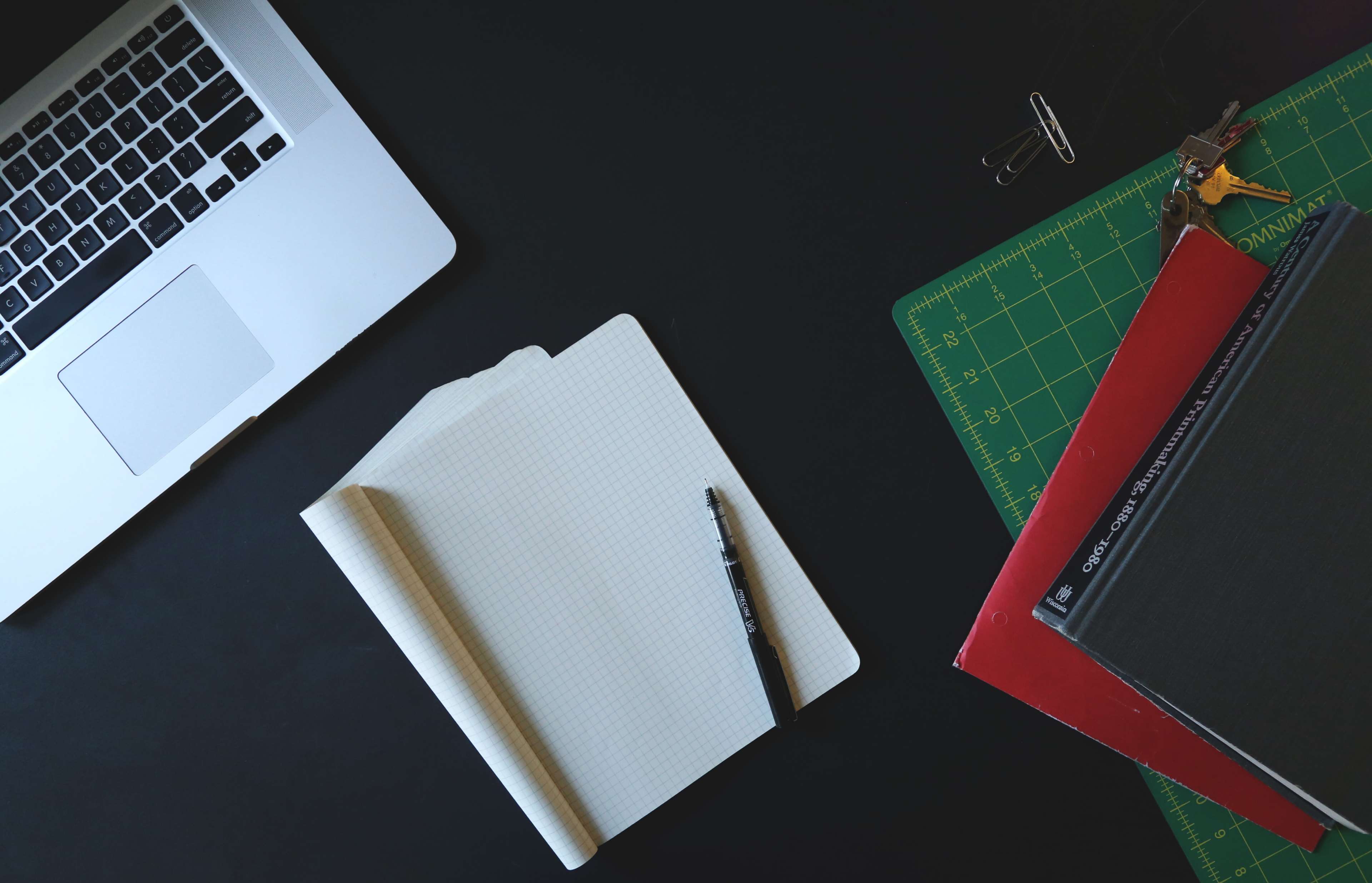 Laptop, notebook, and supplies on a desk 4K HD Wallpaper
