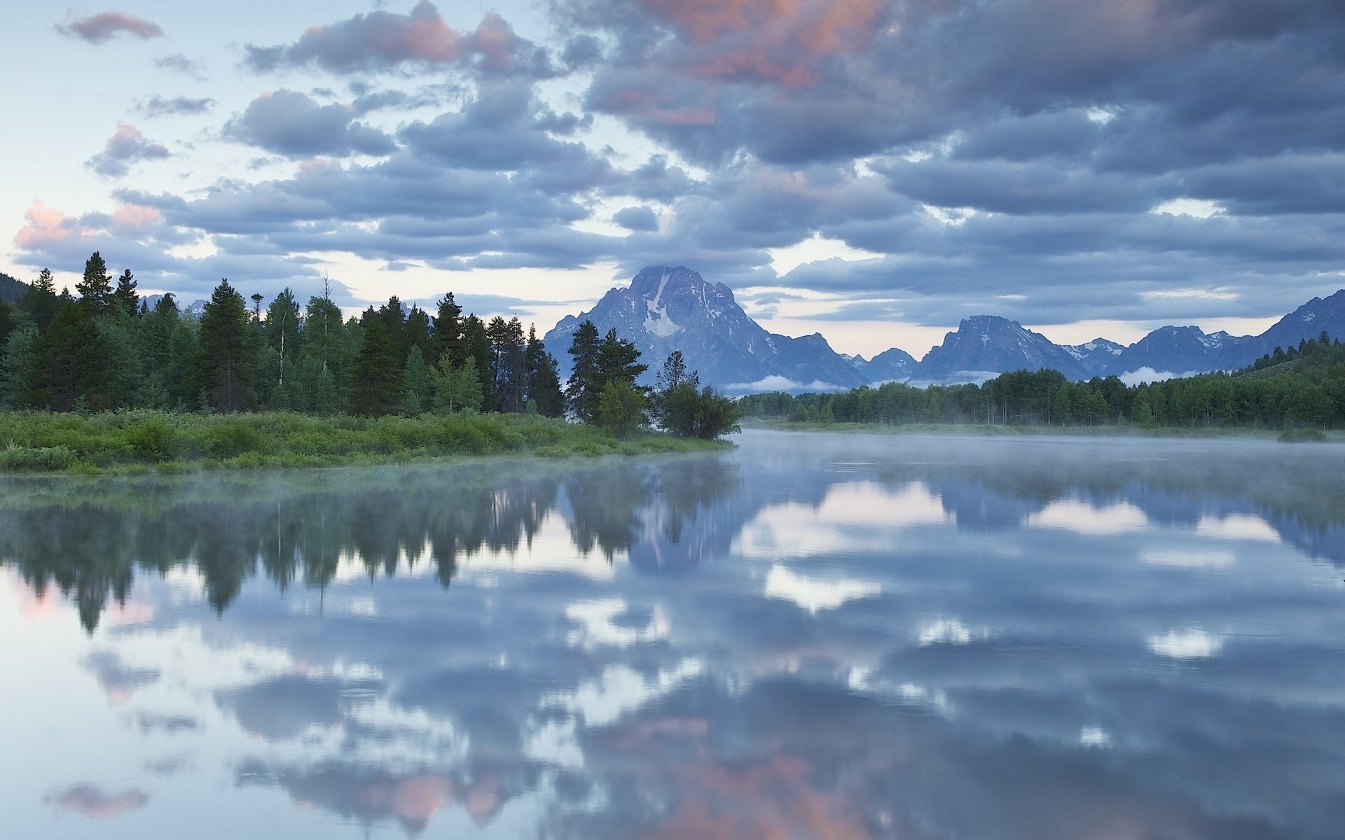 Mountains reflected in a misty lake at sunrise HD Wallpaper