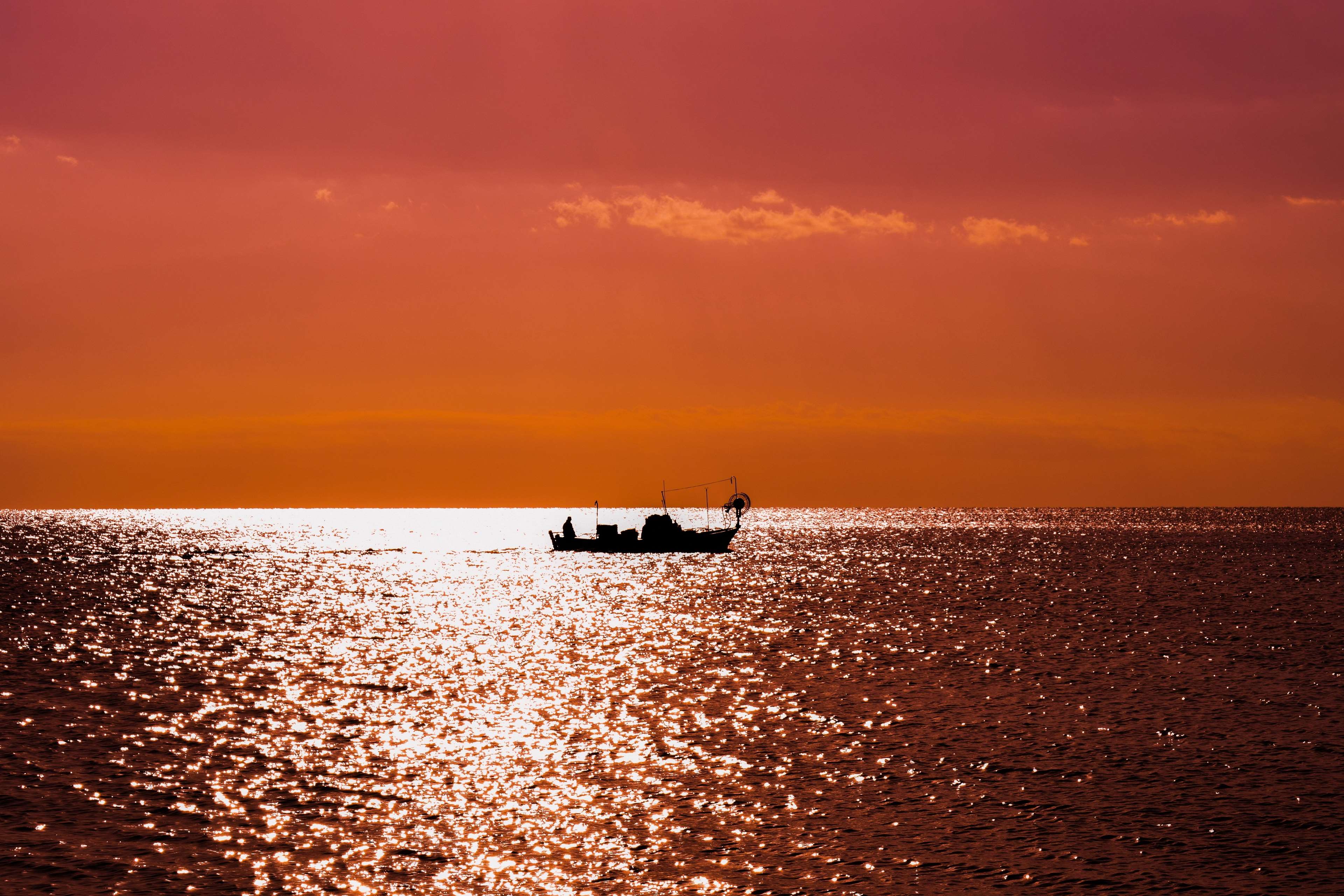 Boat on the sea at sunset in Cyprus HD Wallpaper