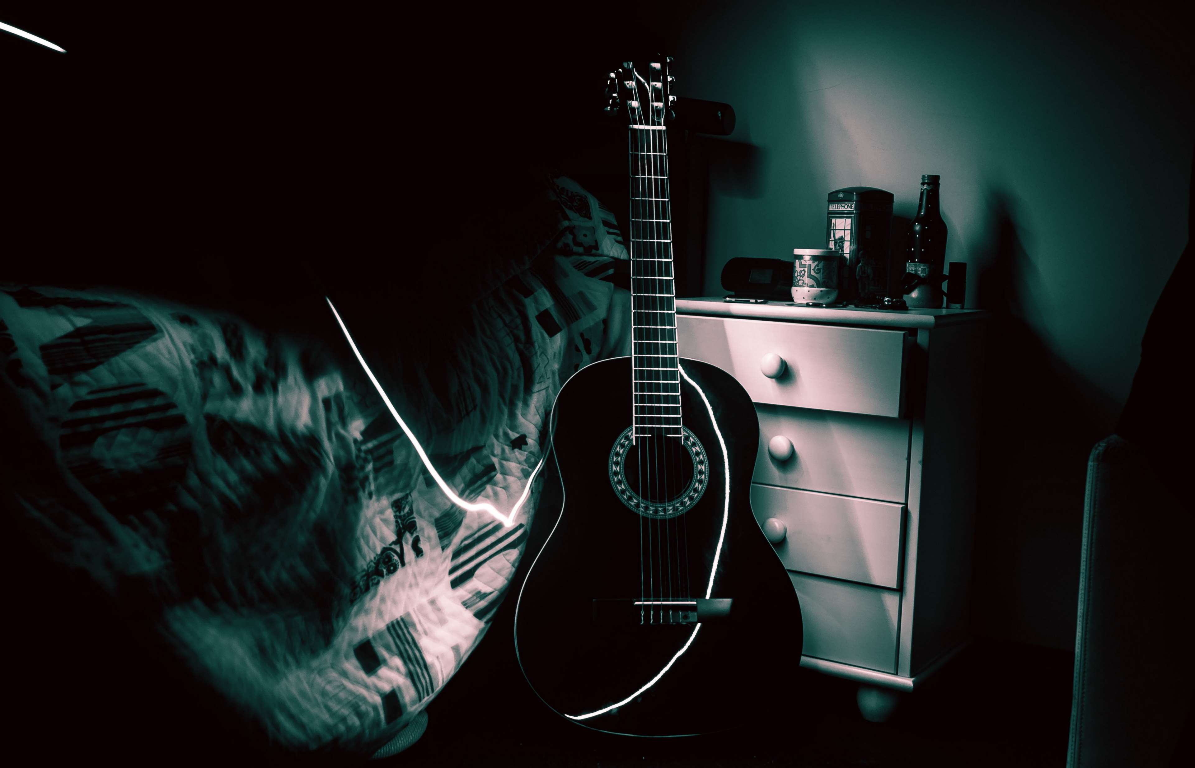 Acoustic guitar in a dark room with a dresser HD Wallpaper