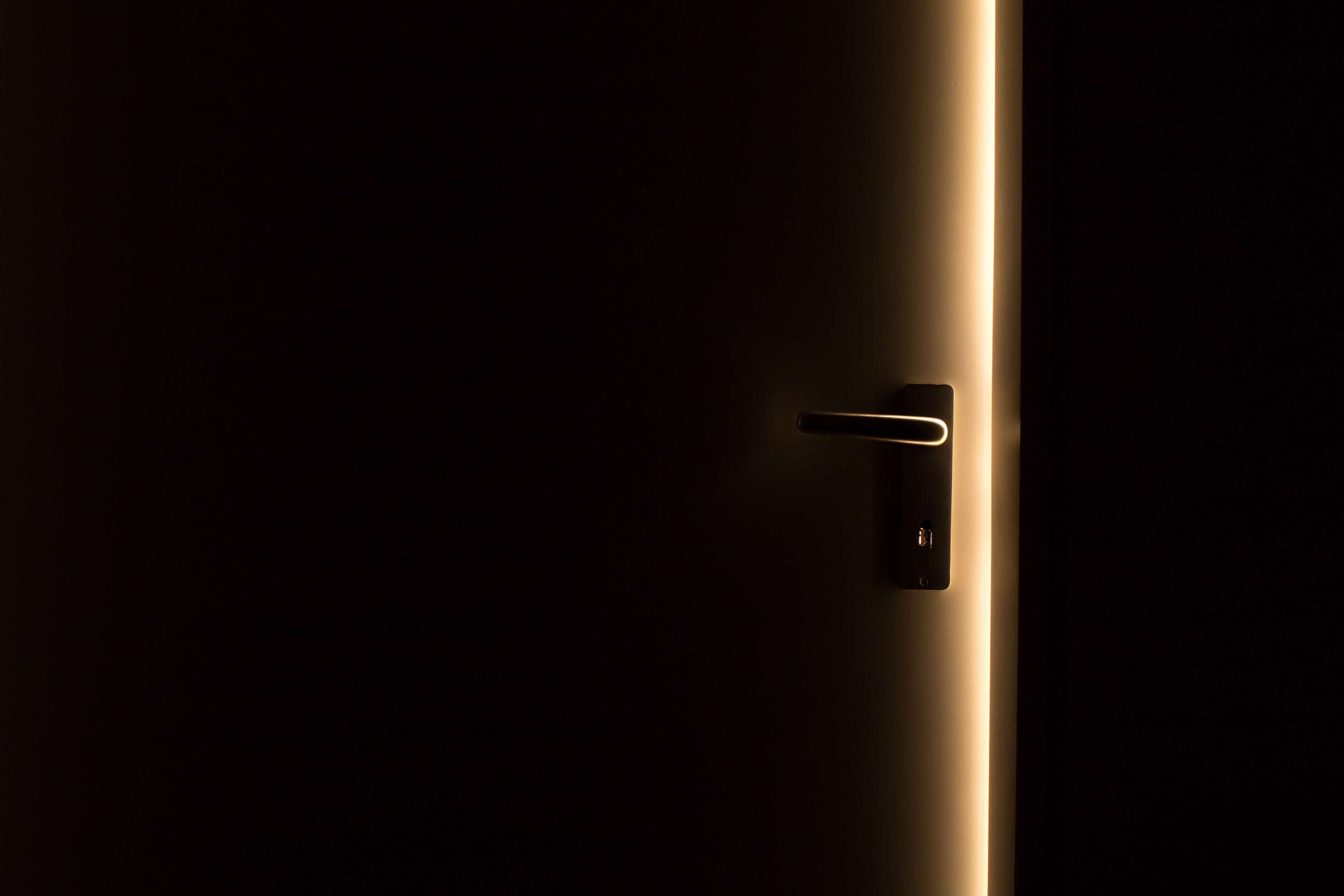 Dark door with illuminated edge and handle HD Wallpaper