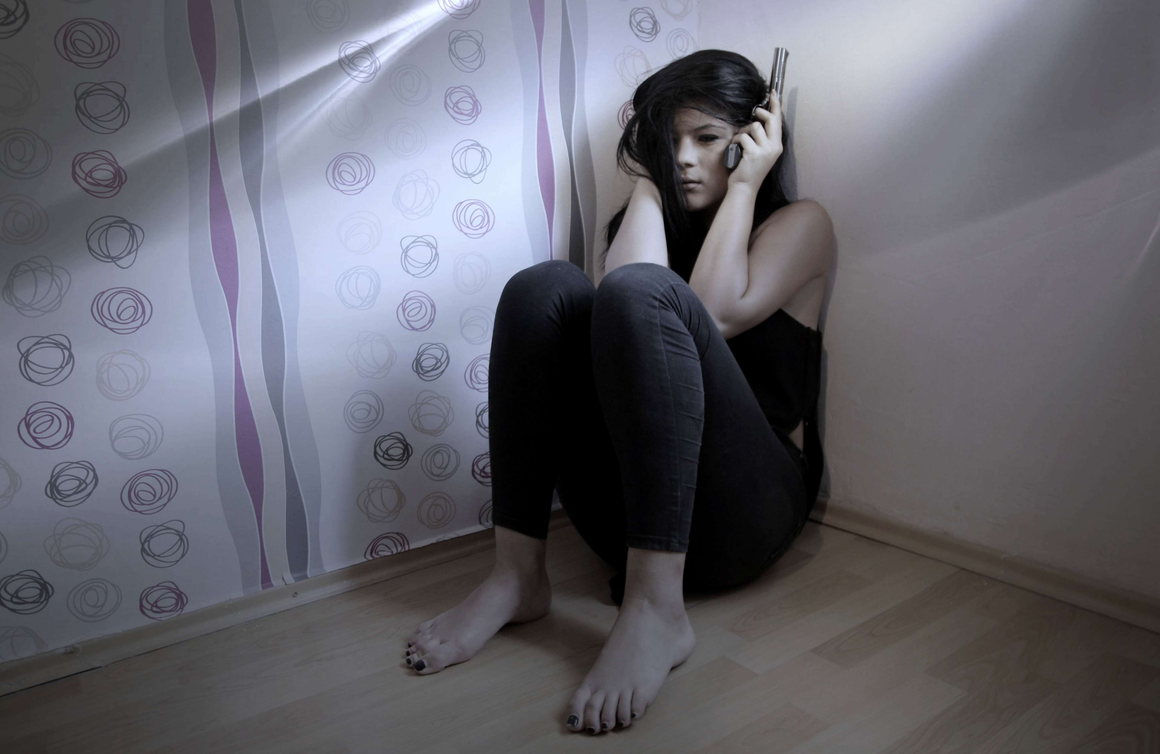 Woman holding a gun in a room HD Wallpaper