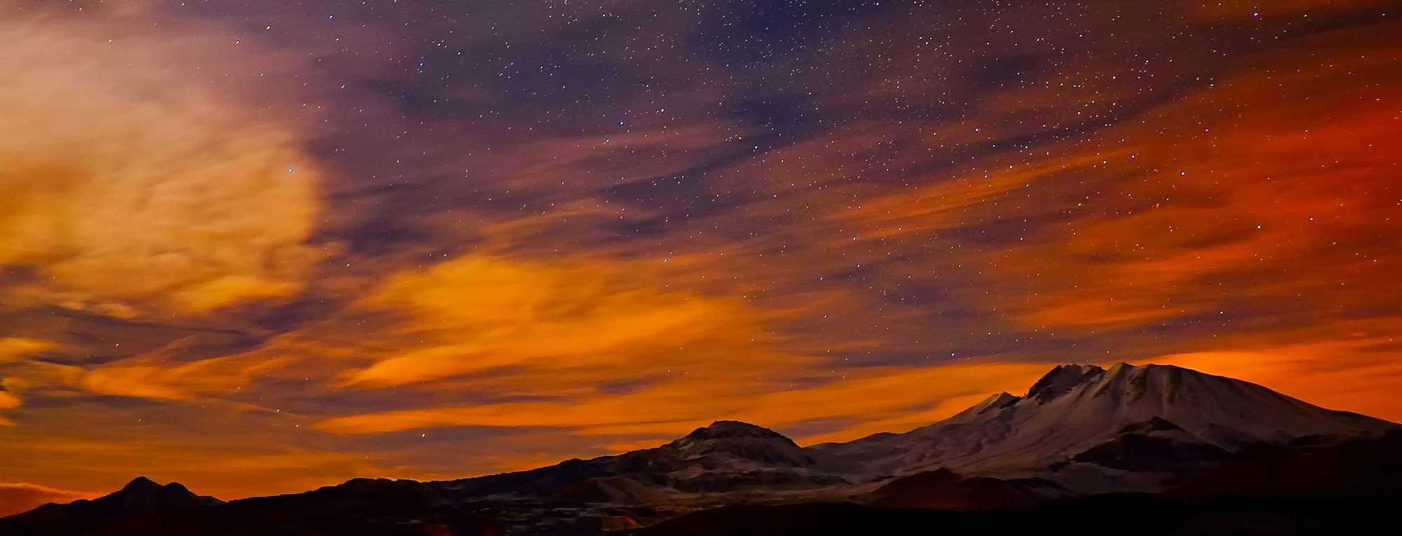 Mountains under a starry sky at sunset HD Wallpaper