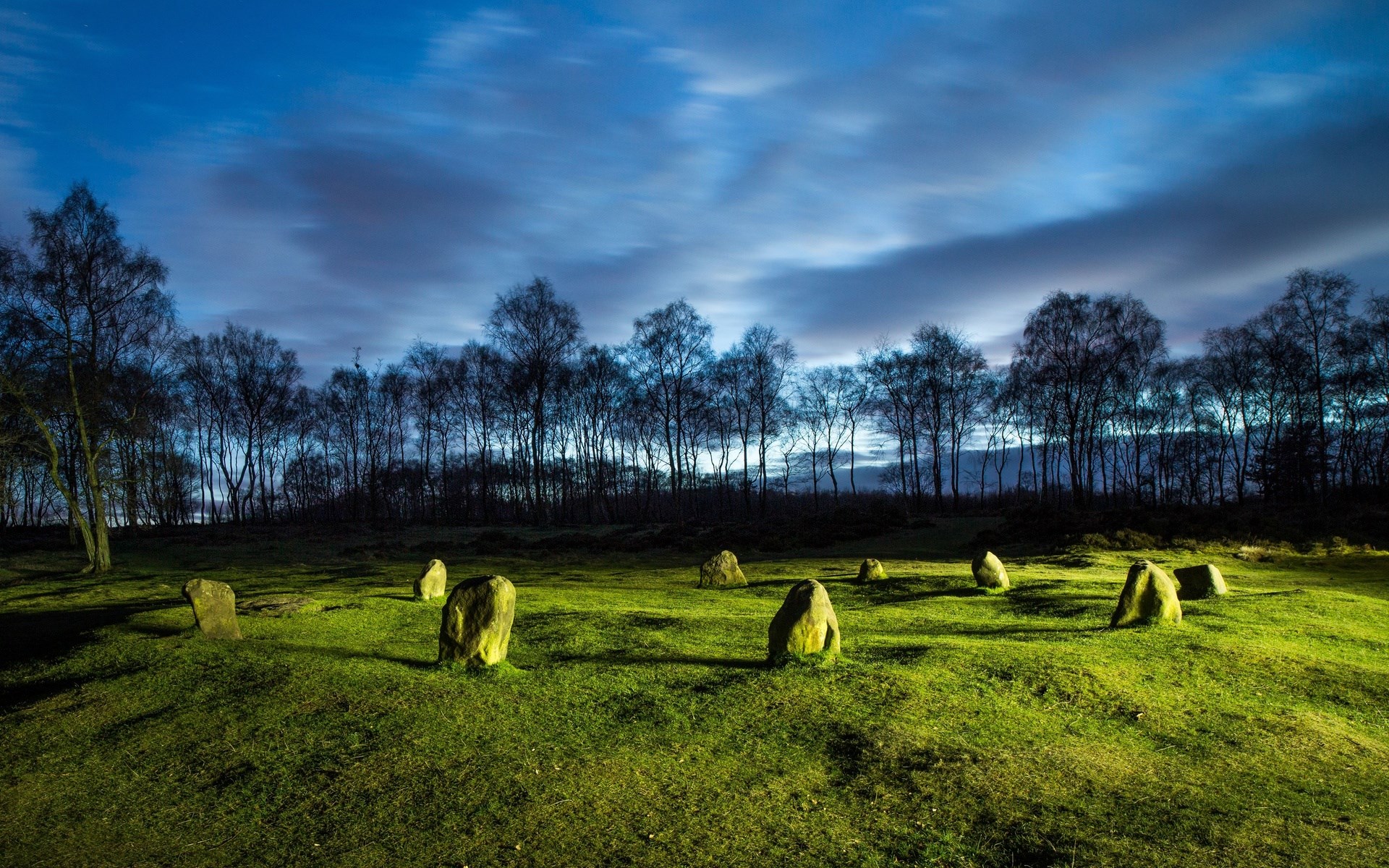Standing stones in a field at dusk HD Wallpaper