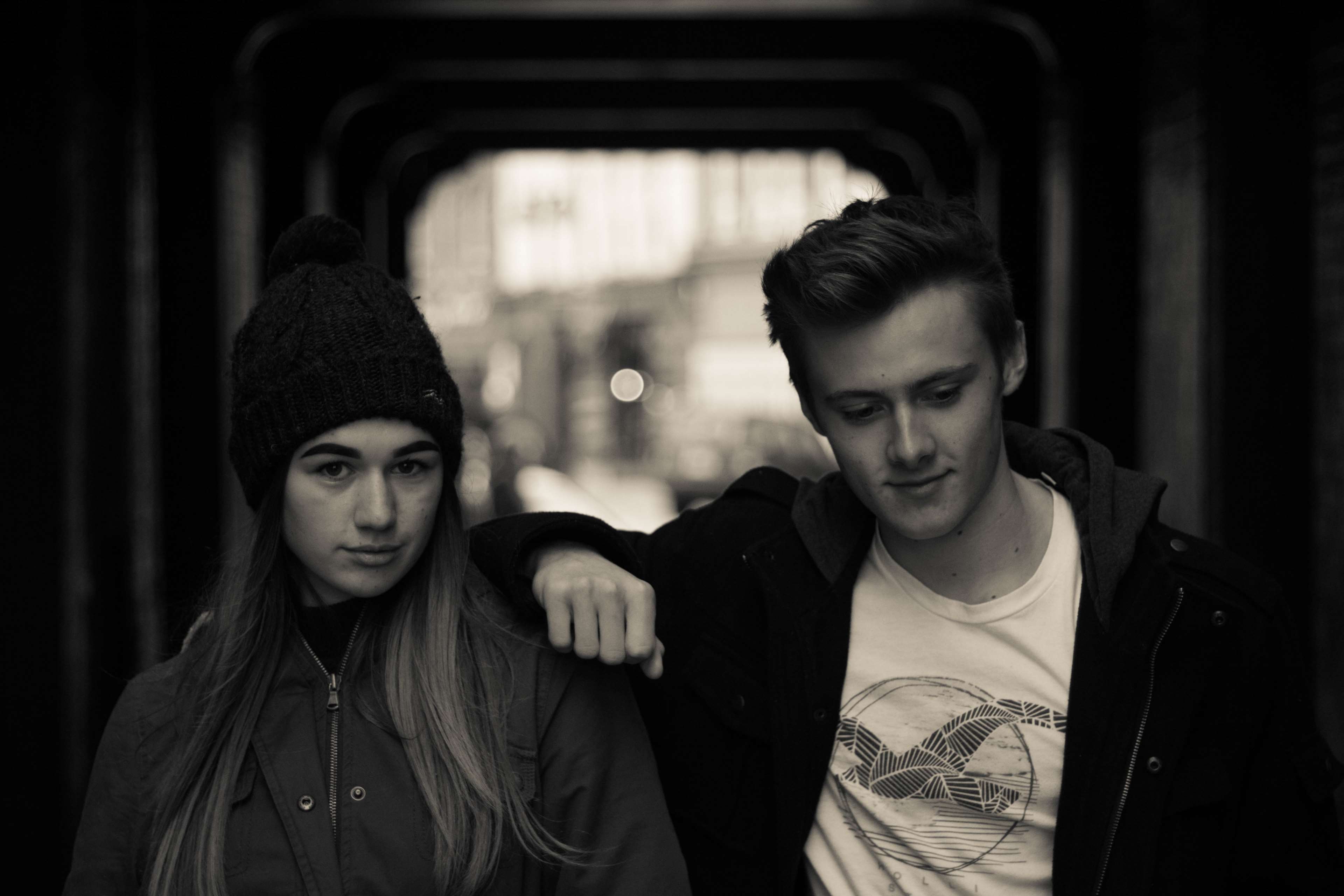 Teenage couple posing in urban setting HD Wallpaper