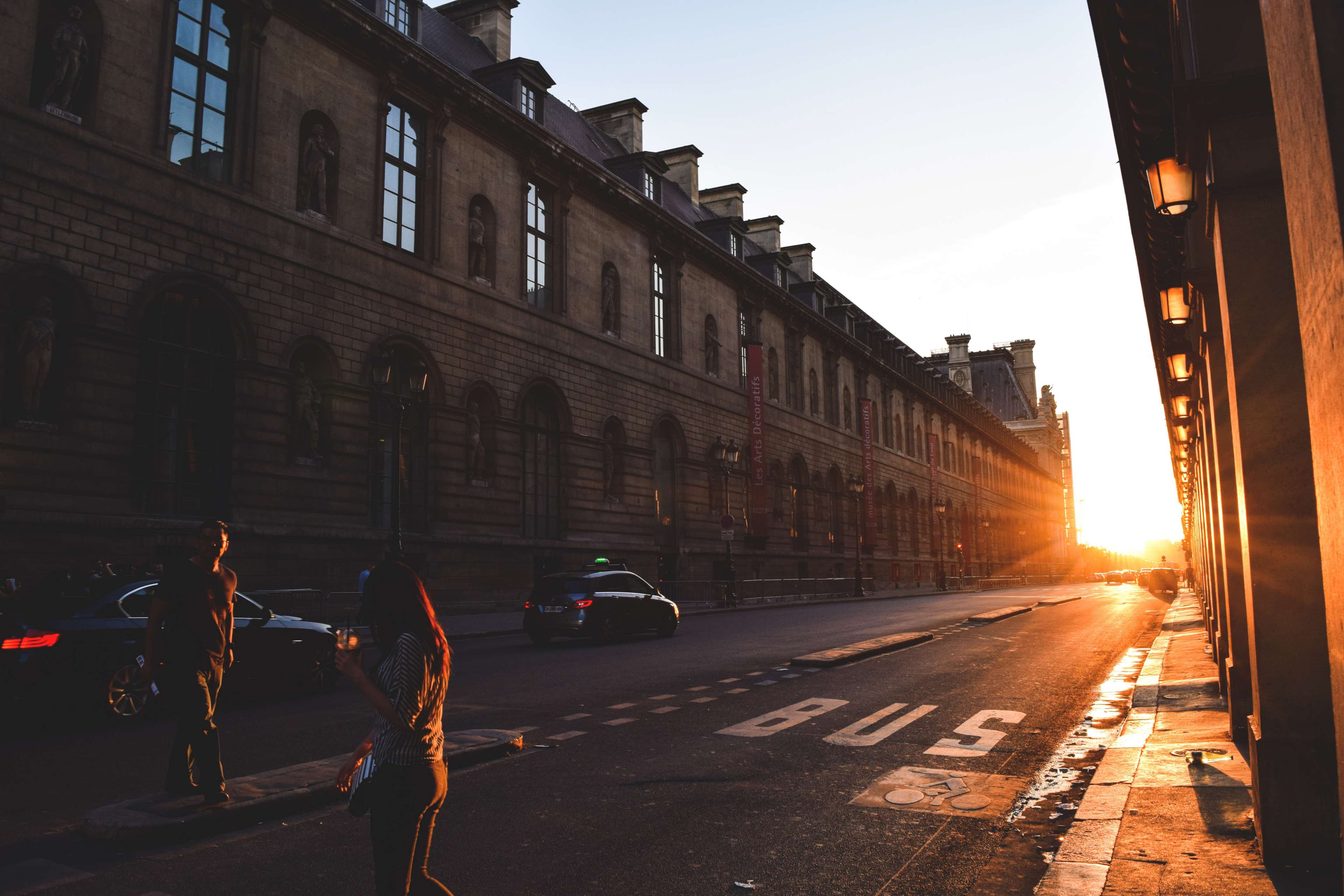 Street scene at sunset with people and cars HD Wallpaper