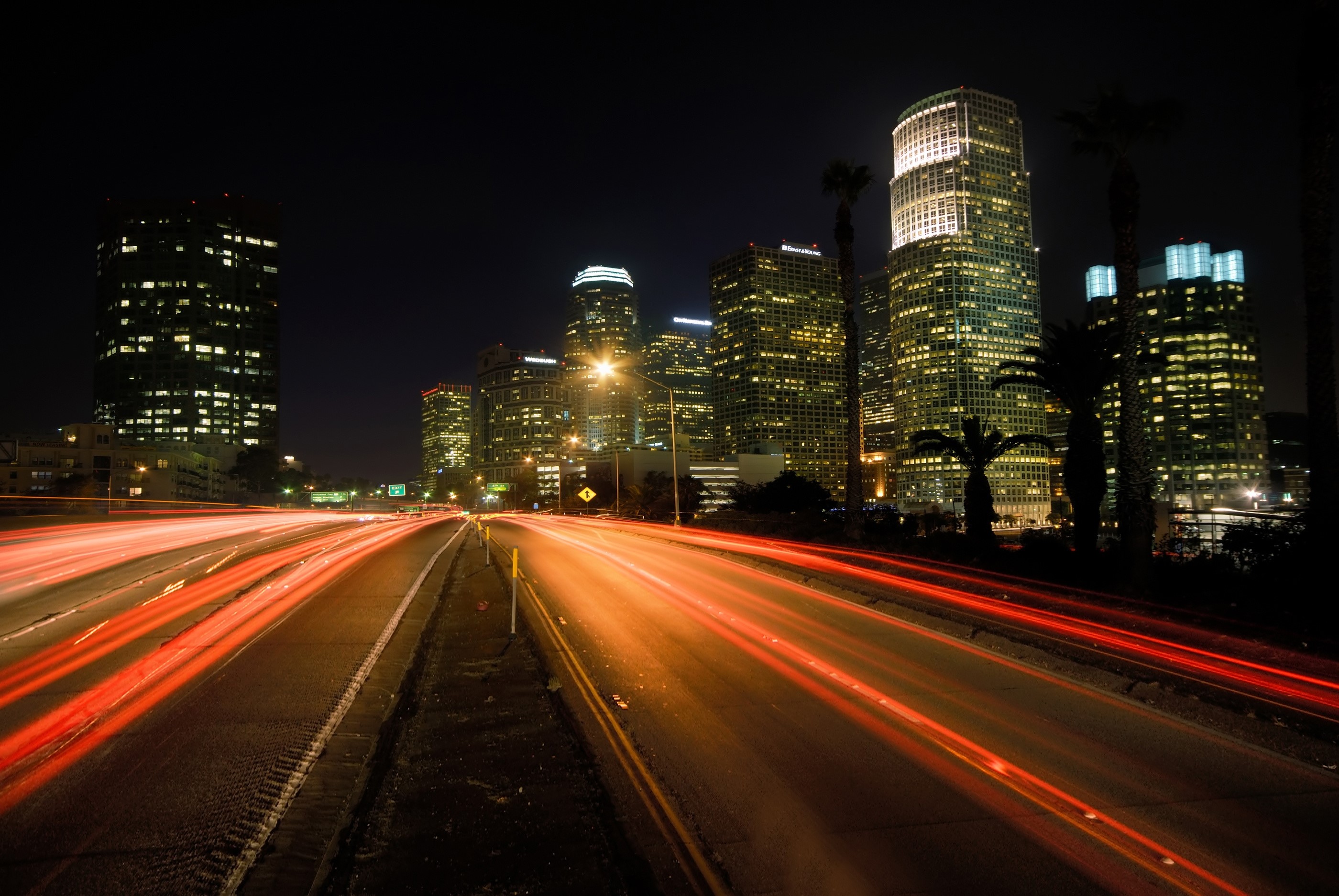 Los Angeles skyline at night with light trails on highway HD Wallpaper