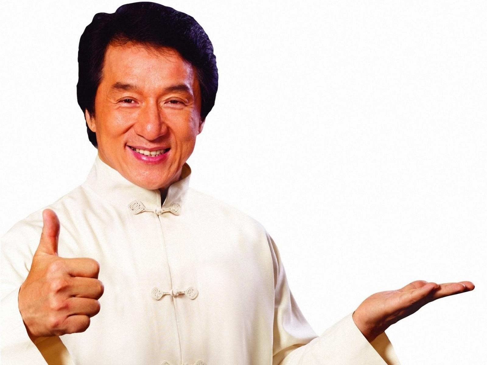 Jackie Chan in a white suit giving a thumbs up HD Wallpaper