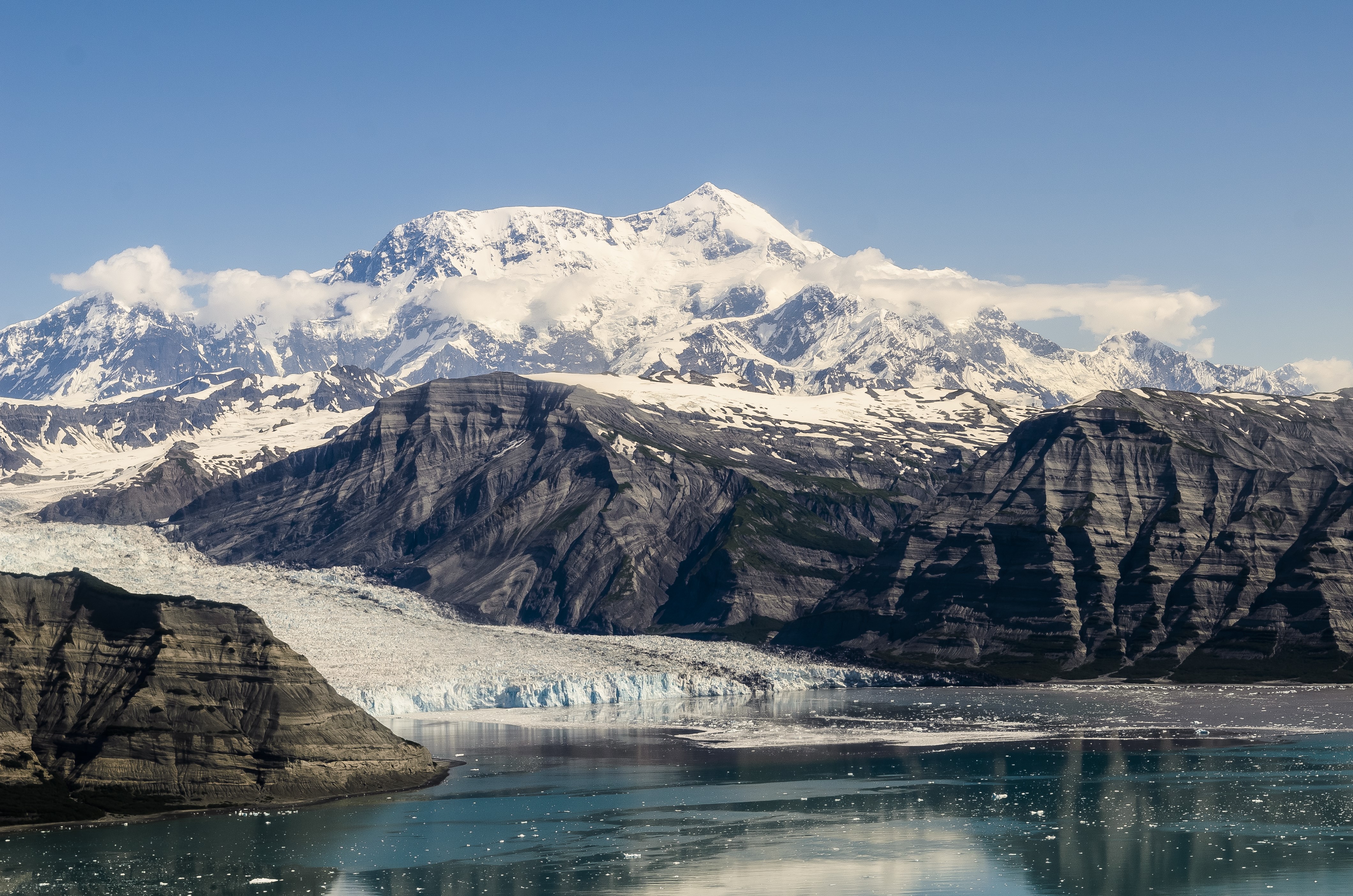 Snow-capped mountains and glacier meeting the ocean HD Wallpaper