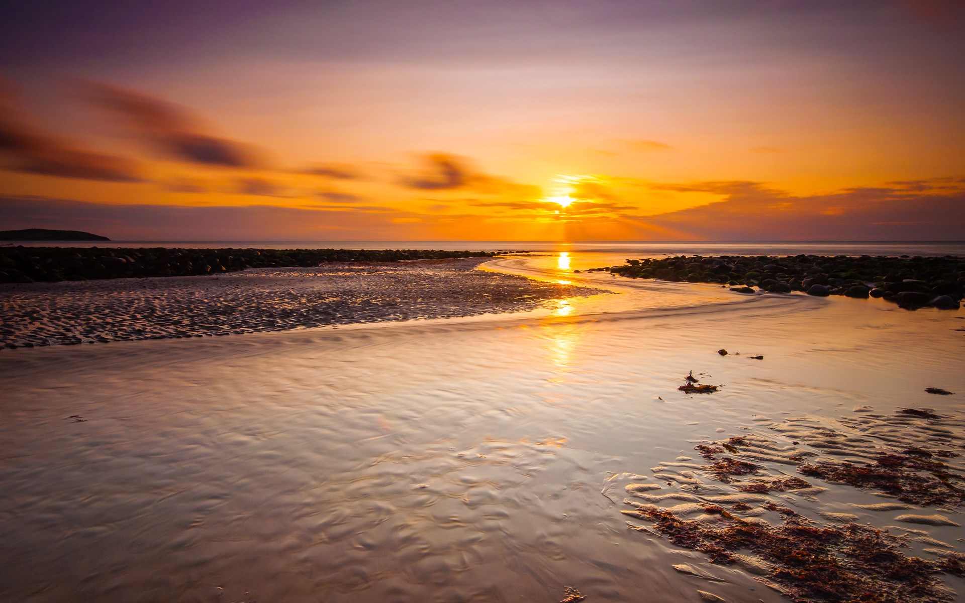 Sunset over a rocky beach with wet sand HD Wallpaper