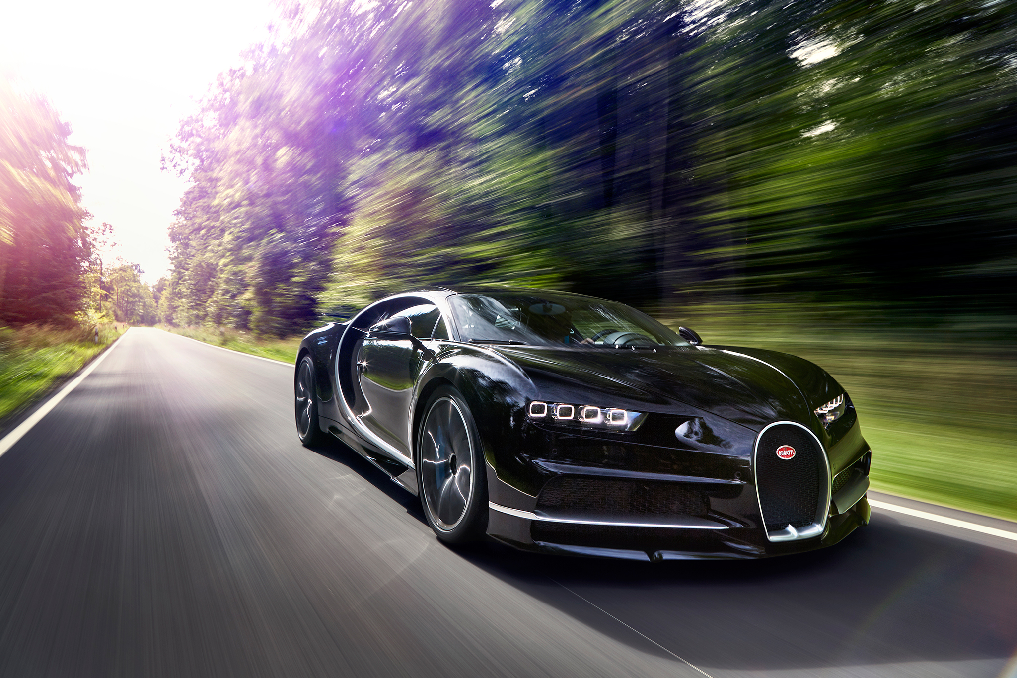 Black Bugatti Chiron driving on a road HD Wallpaper