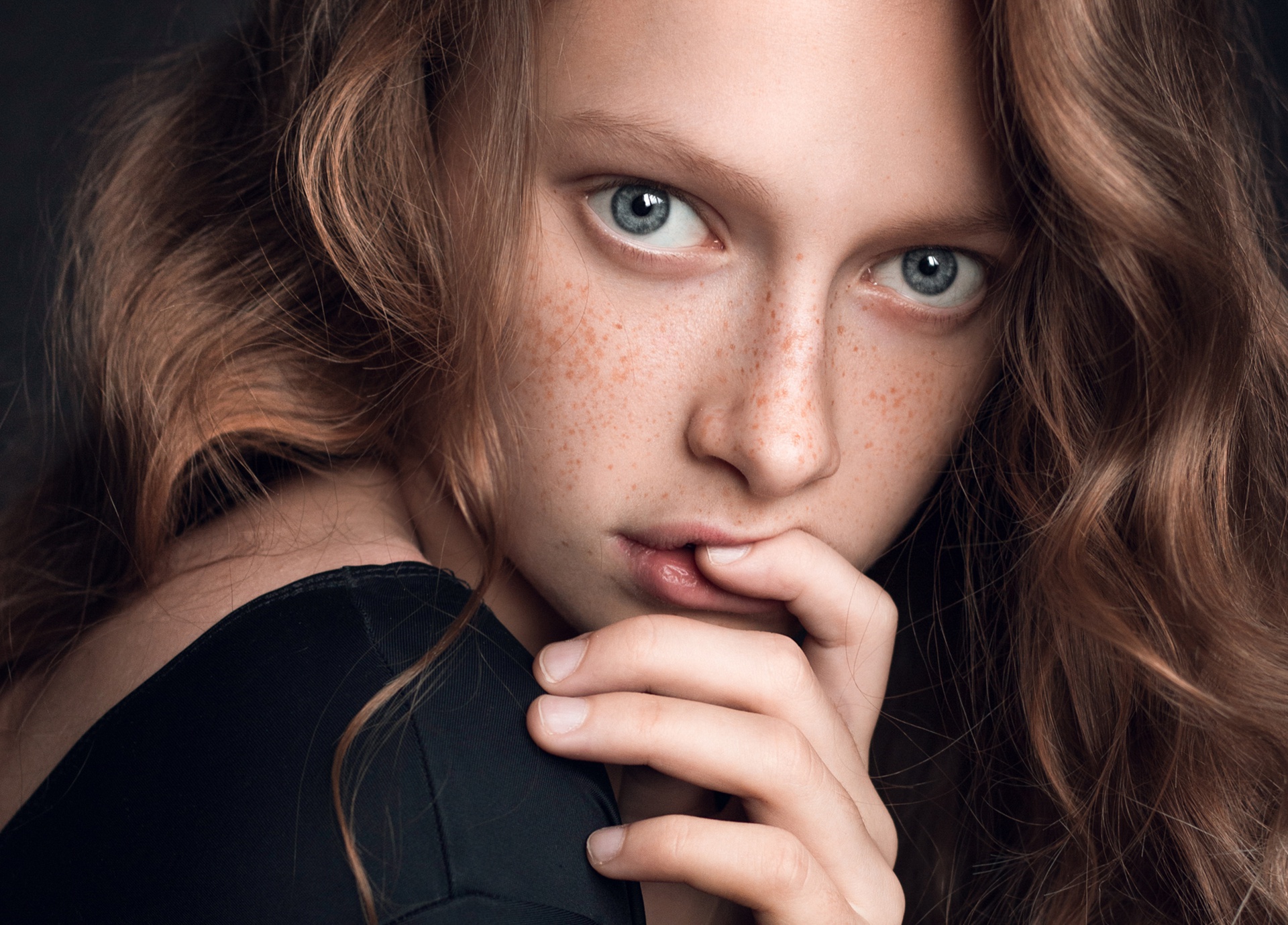 Young woman with freckles and blue eyes HD Wallpaper