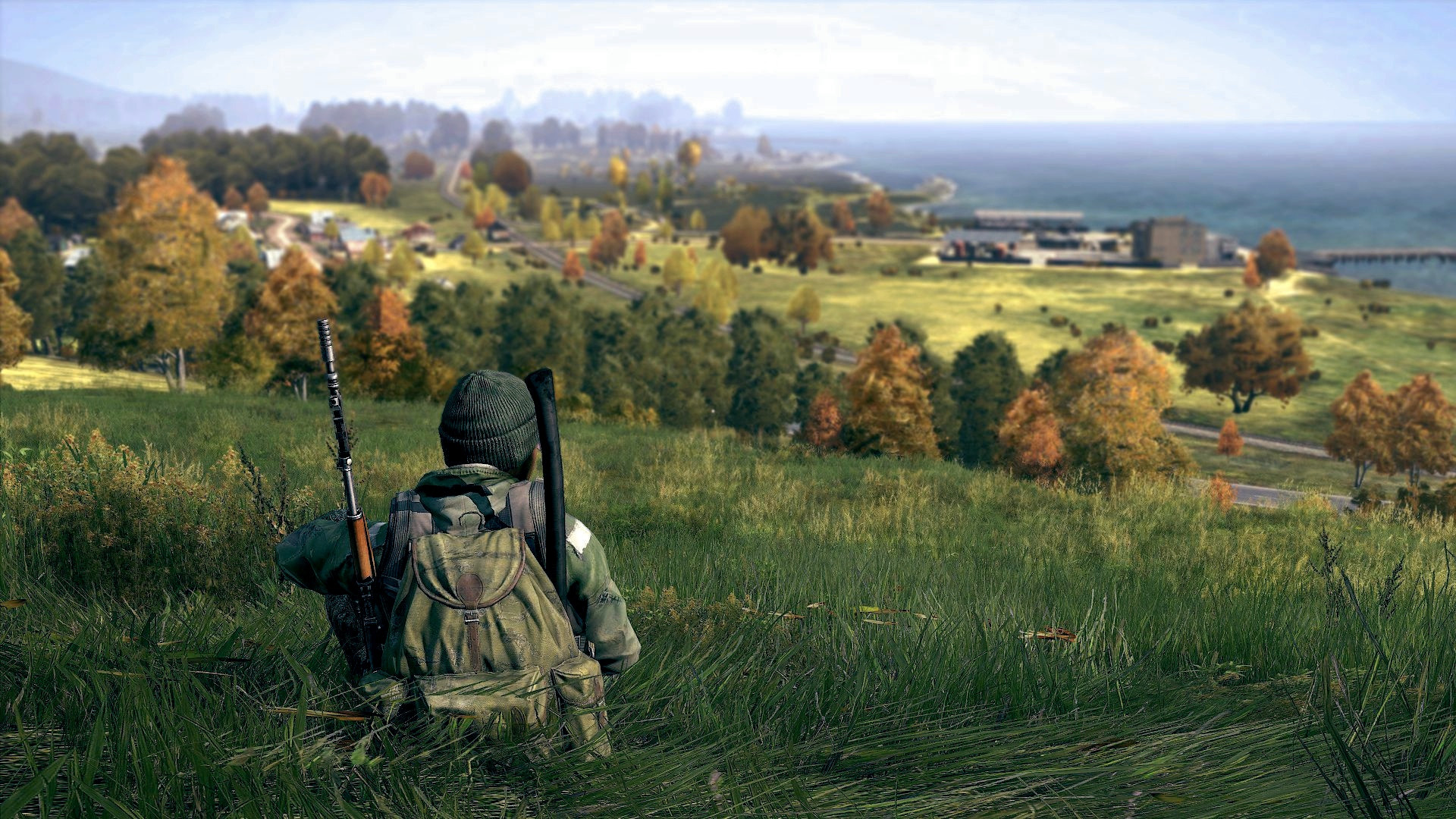 Soldier with rifle overlooking a coastal town in DayZ HD Wallpaper