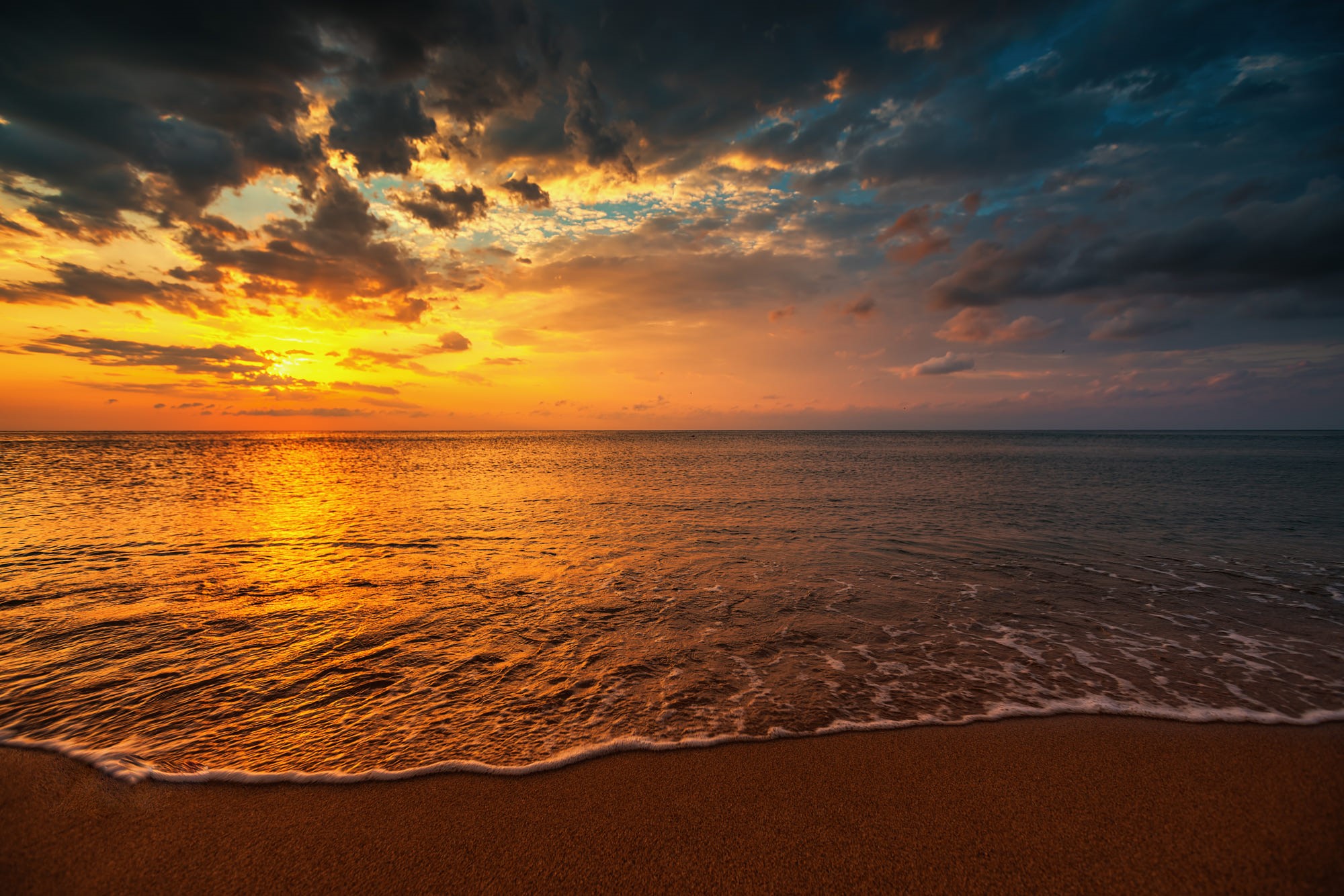 Sunset over the ocean with dramatic clouds HD Wallpaper