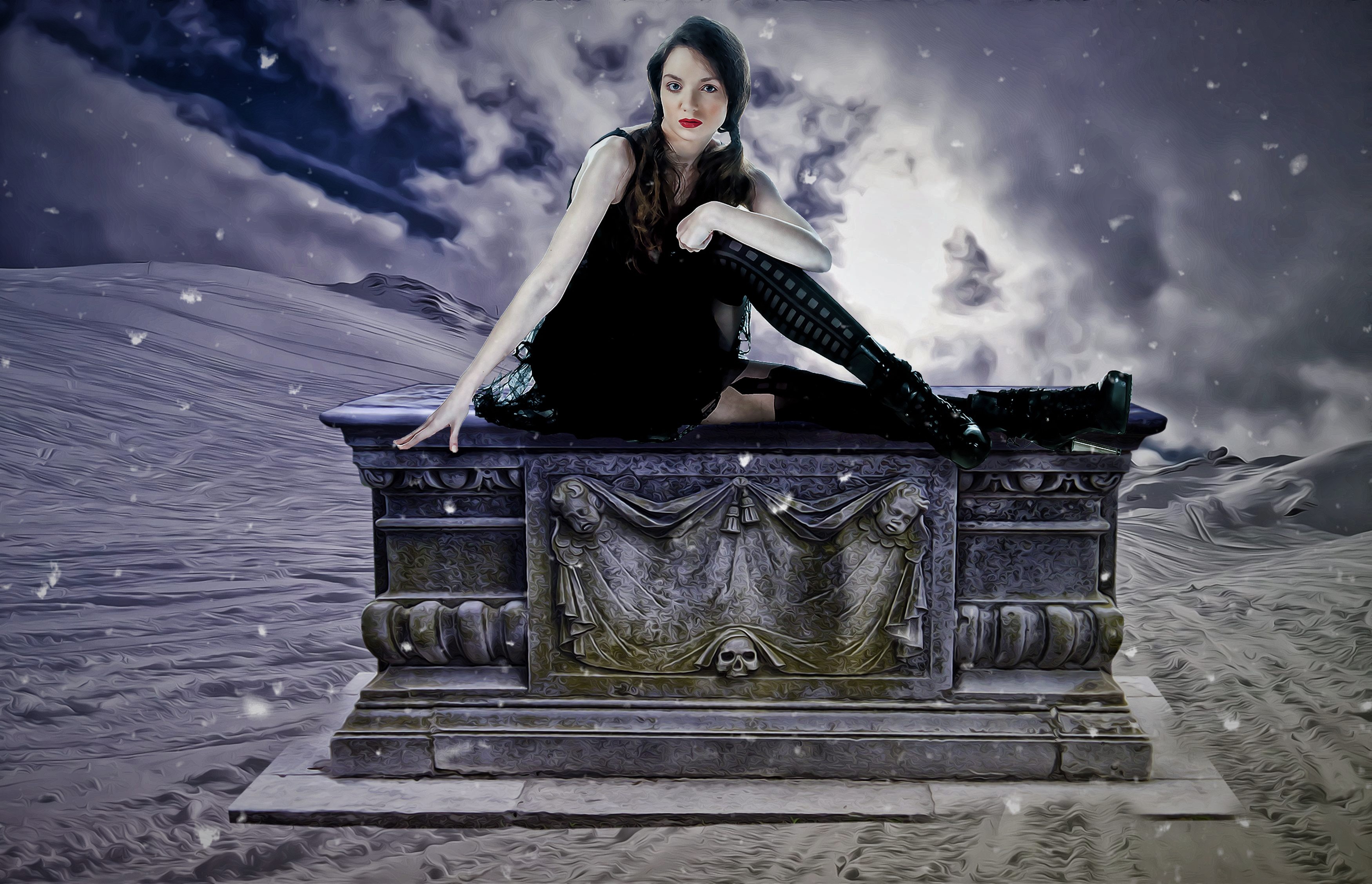 Gothic woman sitting on a tombstone in a snowy landscape HD Wallpaper