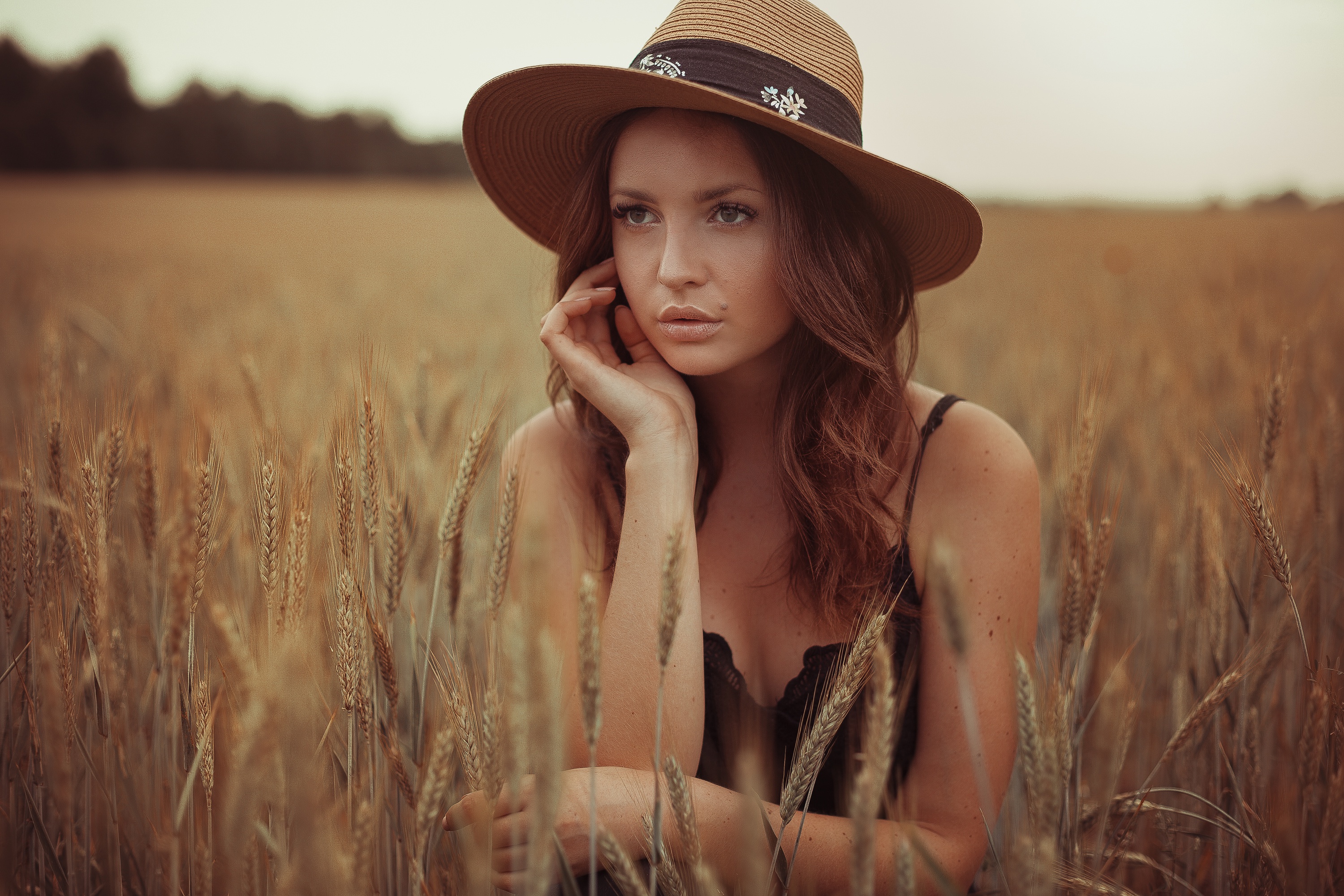 Woman in a hat in a wheat field HD Wallpaper