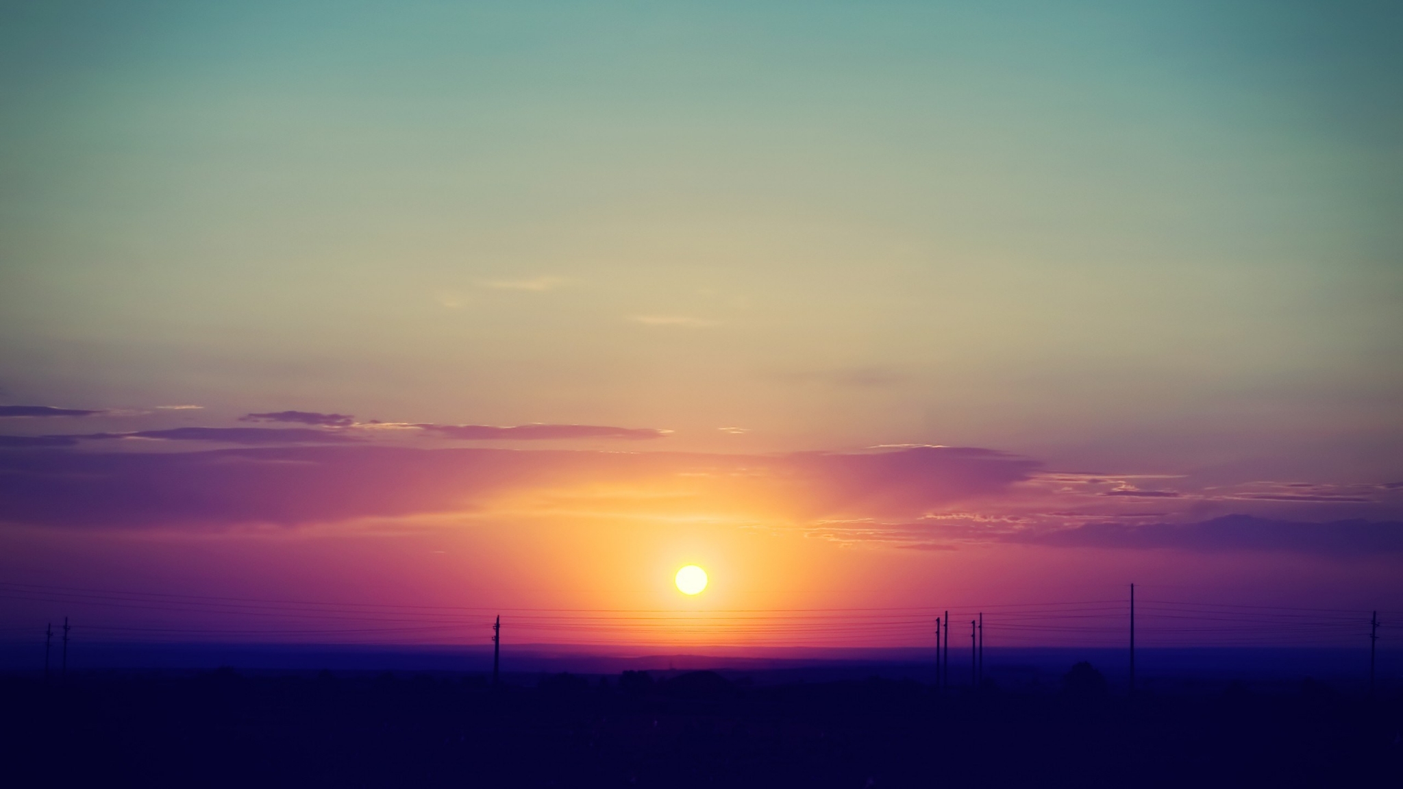 Sunset over a field with power lines HD Wallpaper