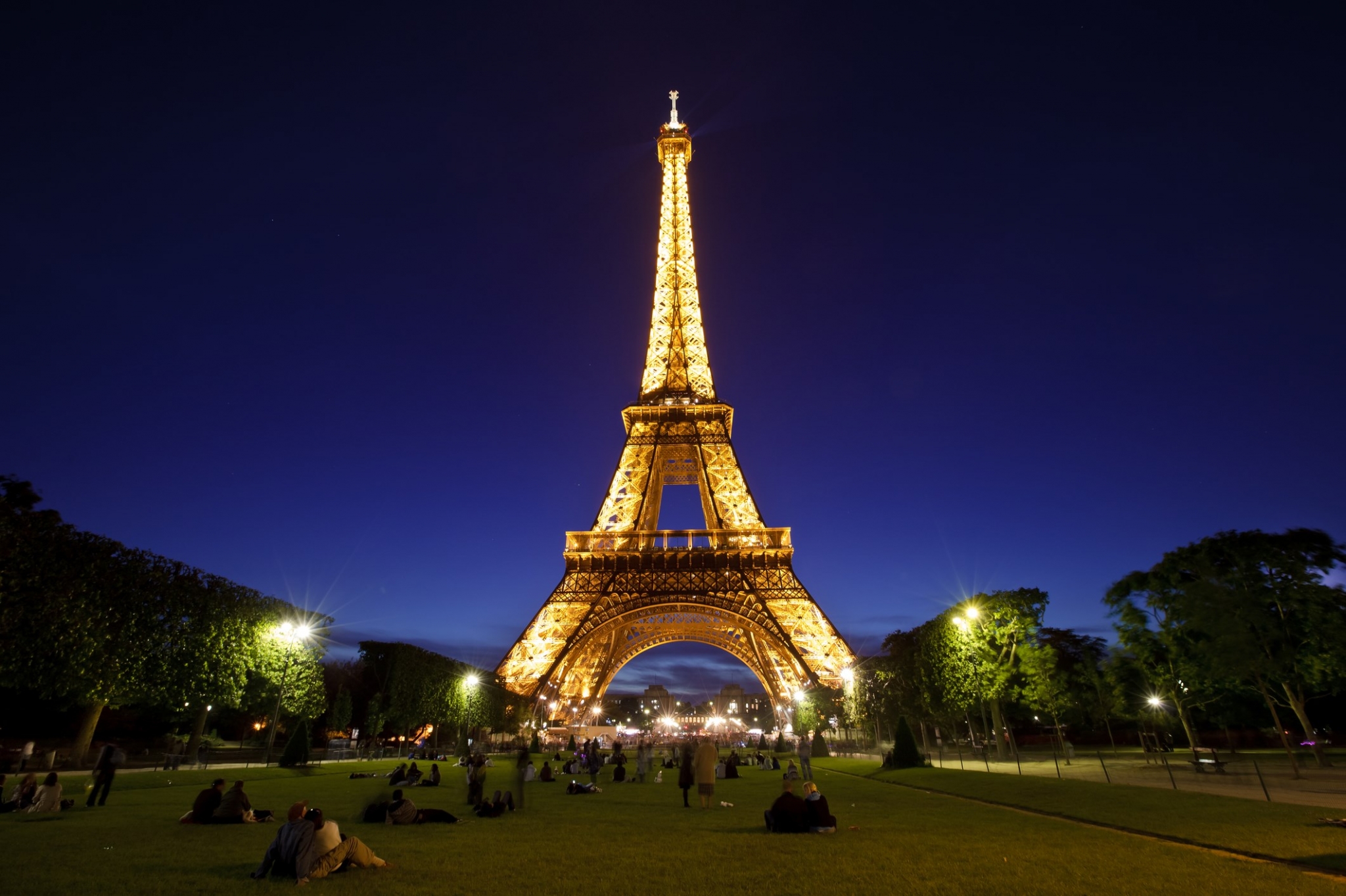 Eiffel Tower at night with people in the park HD Wallpaper