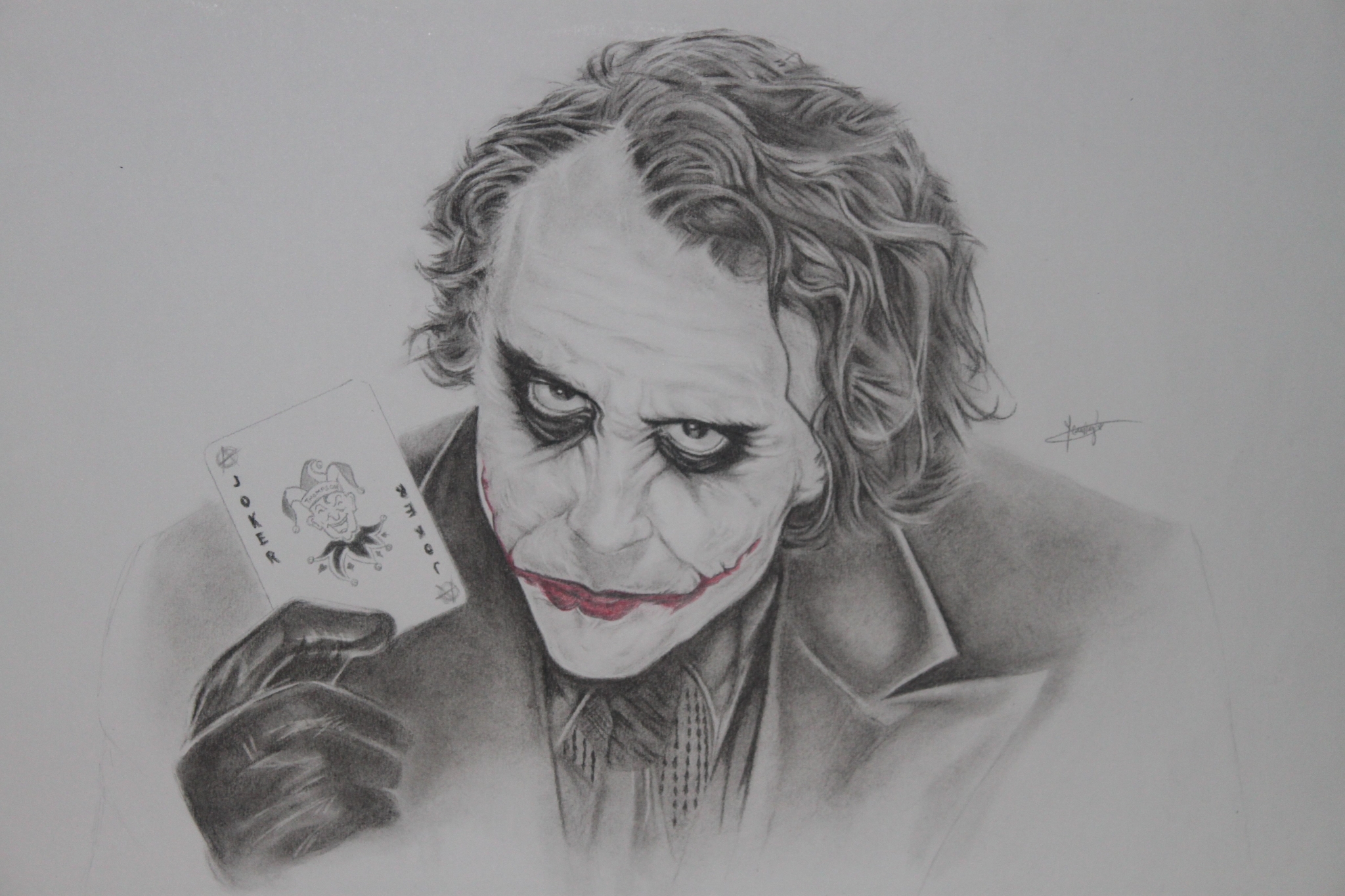 The Joker holding a Joker card HD Wallpaper