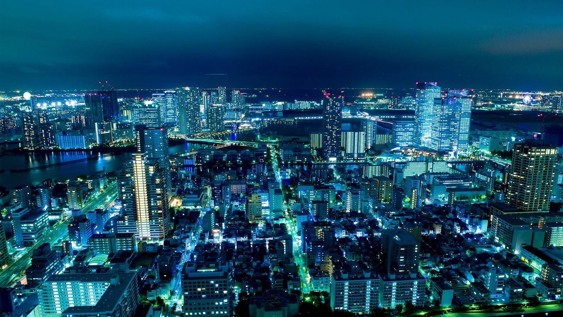 Aerial view of a city at night HD Wallpaper