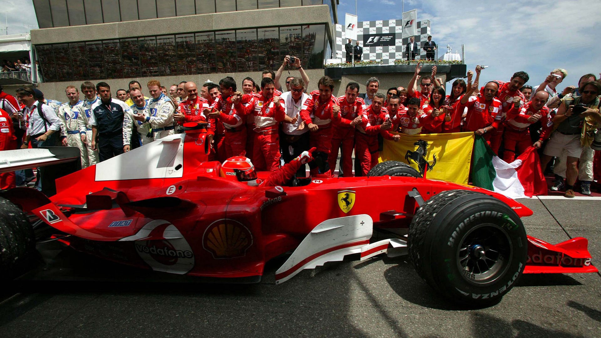 Michael Schumacher and Ferrari team with Italian flag HD Wallpaper