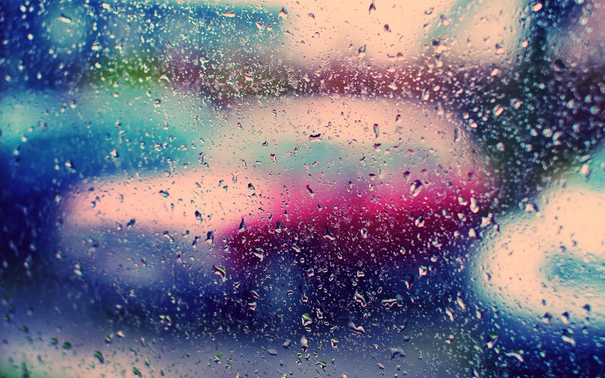 Raindrops on a window with blurred colorful background HD Wallpaper