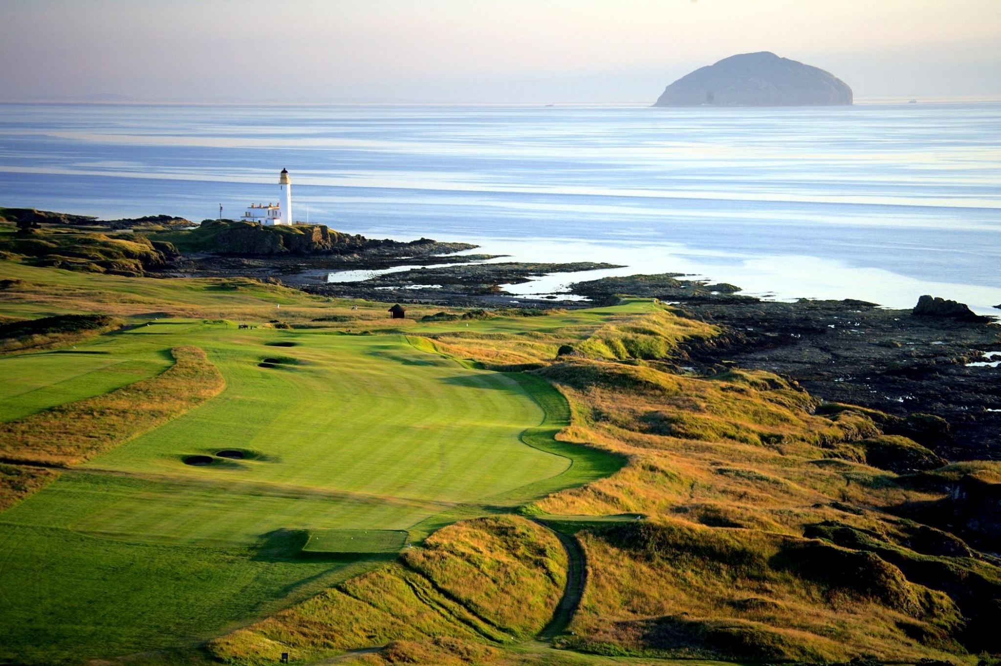 Golf course with lighthouse and island HD Wallpaper