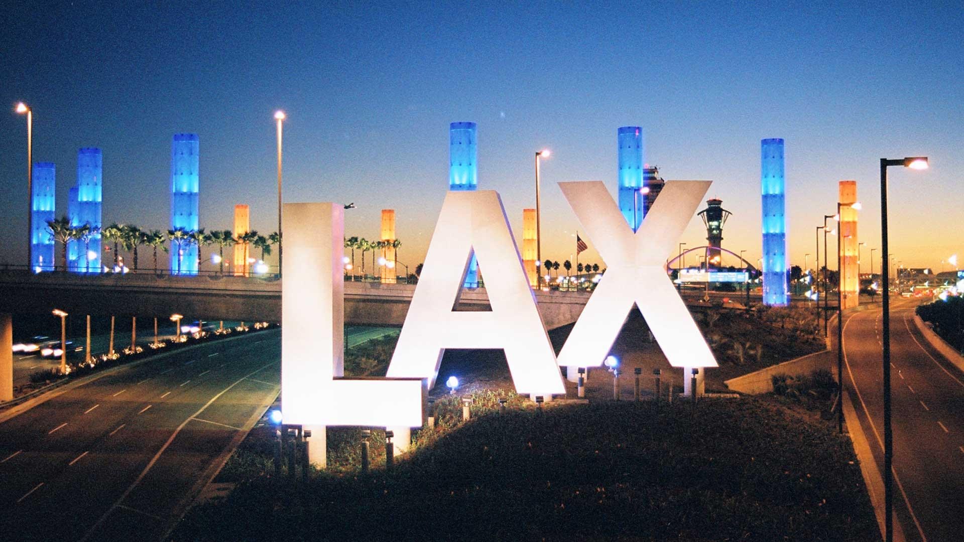 LAX airport sign at dusk with illuminated towers HD Wallpaper