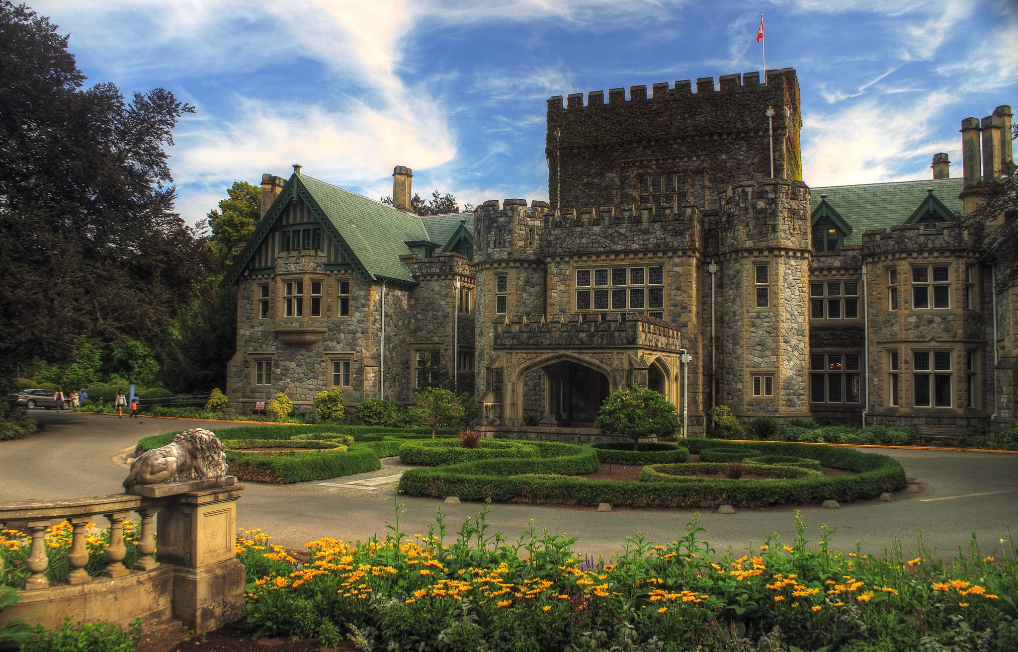 Castle with manicured gardens and lion statue HD Wallpaper