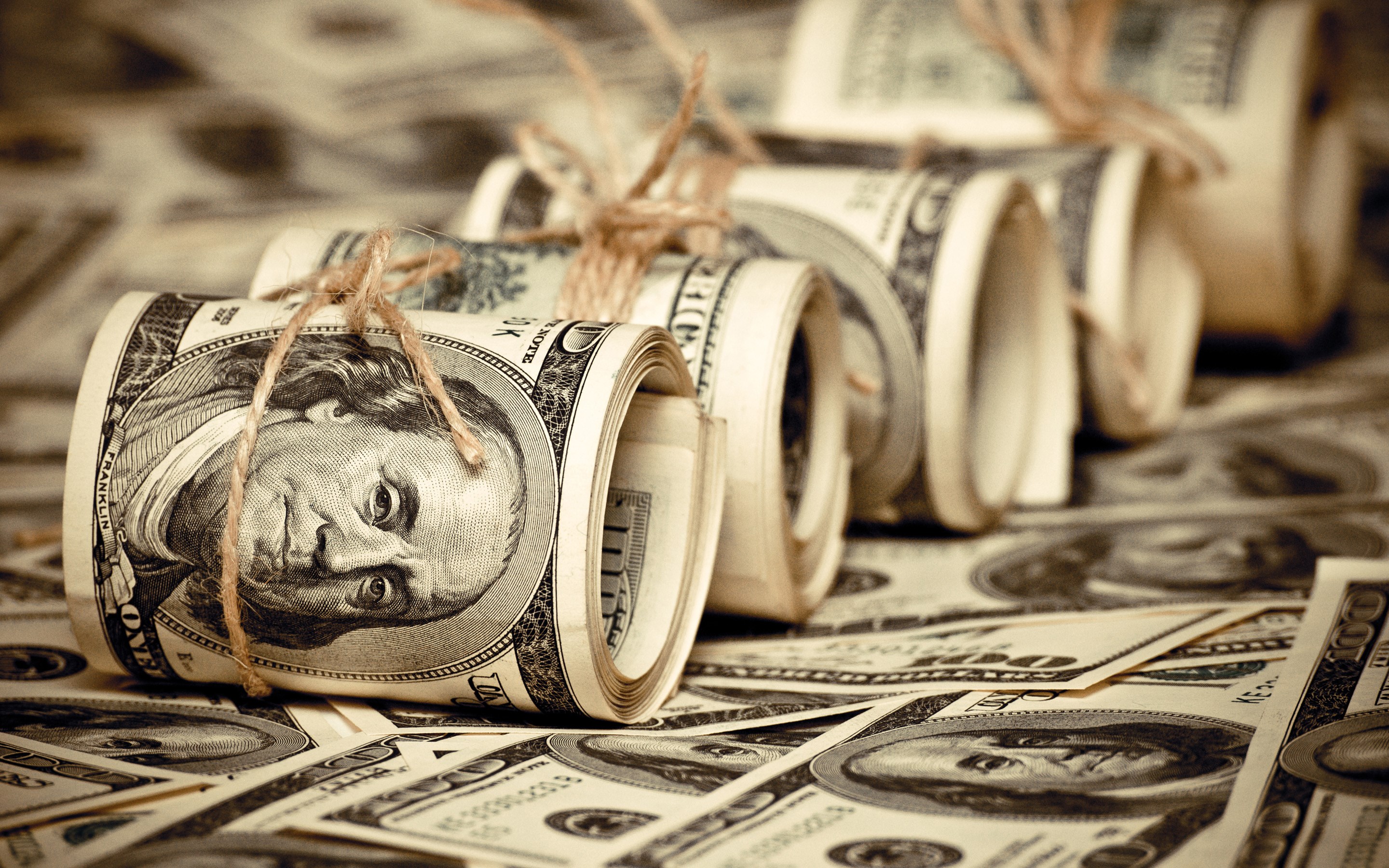 Rolls of US Dollar Bills Tied with Twine HD Wallpaper