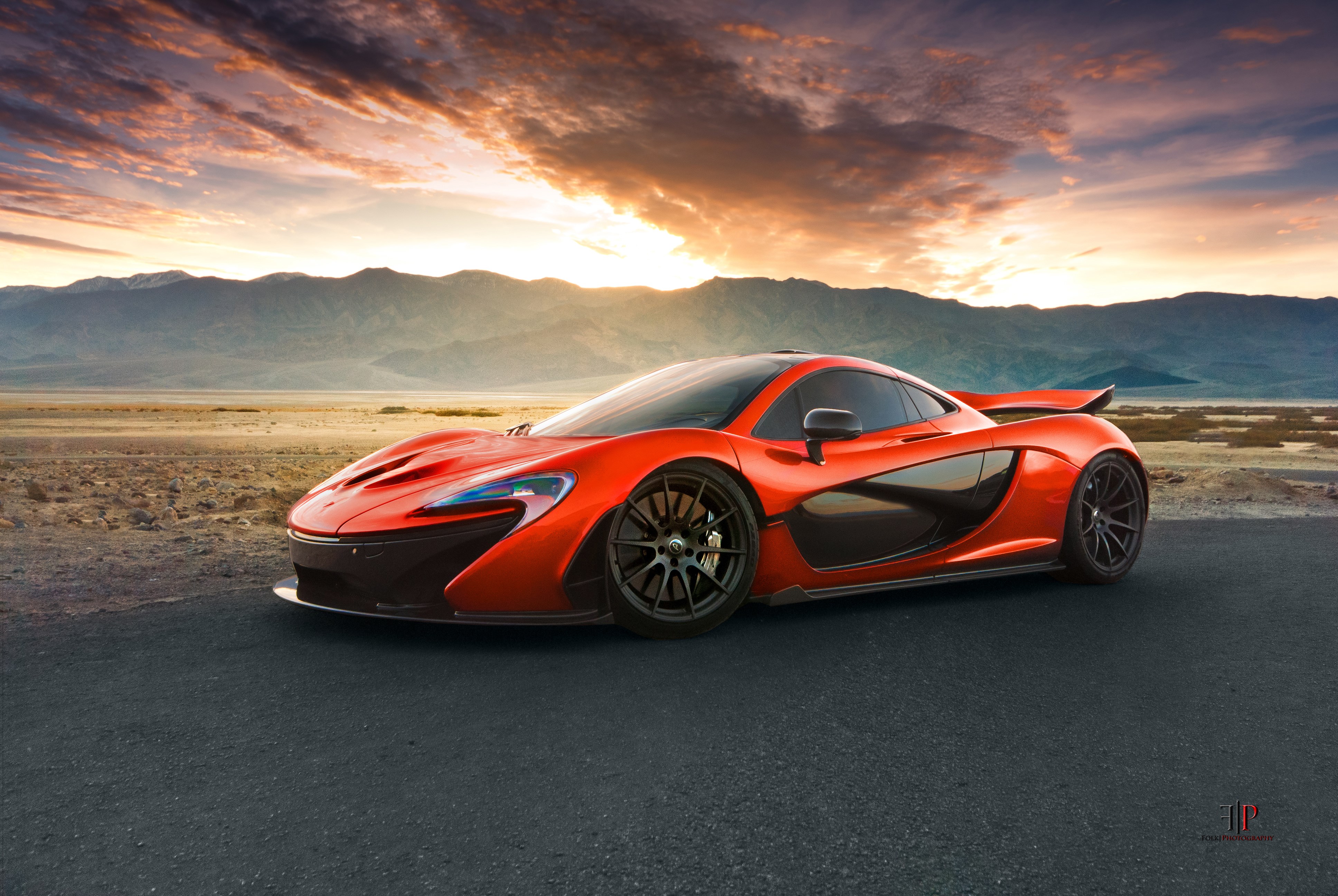 Orange McLaren P1 supercar in desert landscape HD Wallpaper