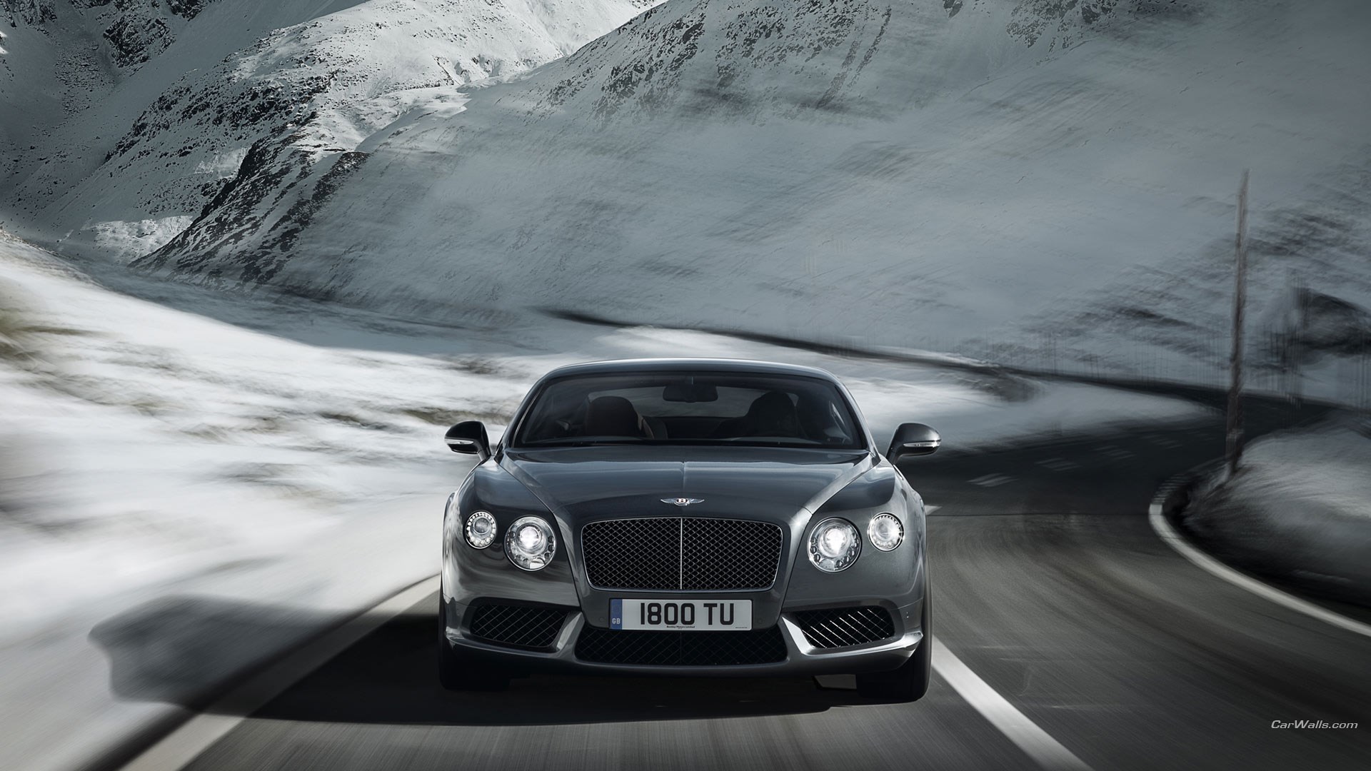 Bentley Continental V8 driving on a snowy mountain road HD Wallpaper