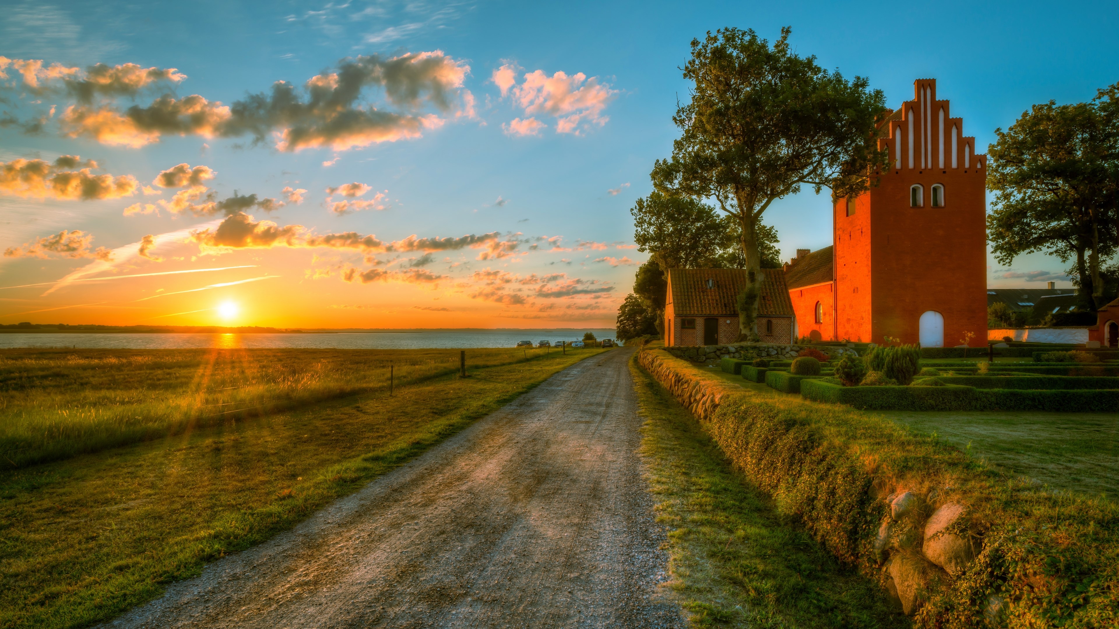 4K Sunset over a rural landscape with a church HD Wallpaper