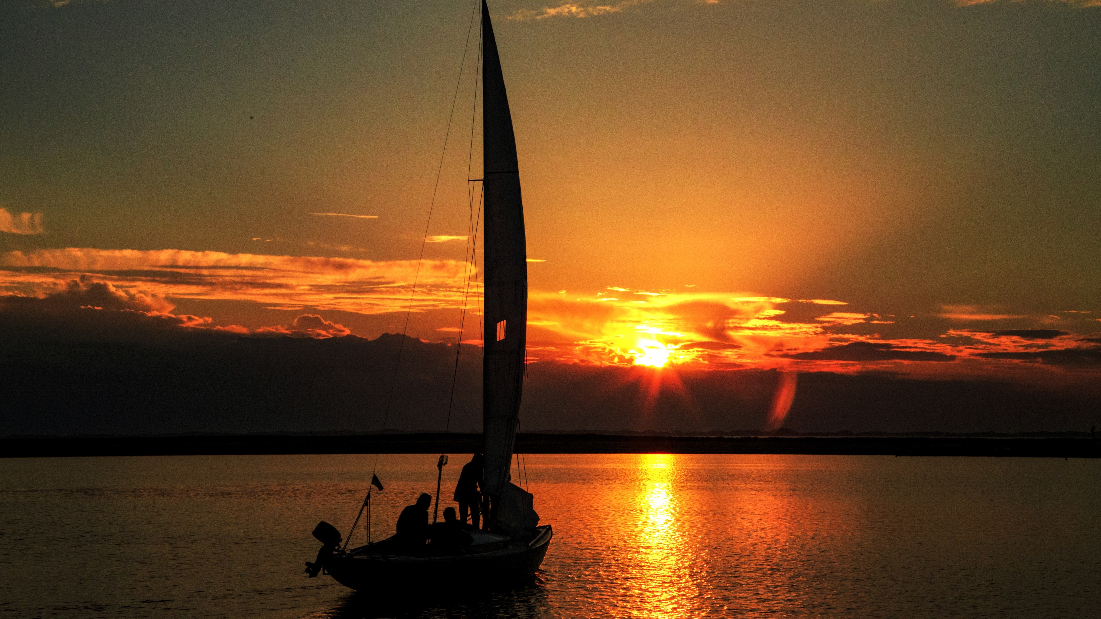Sailboat on the water at sunset HD Wallpaper