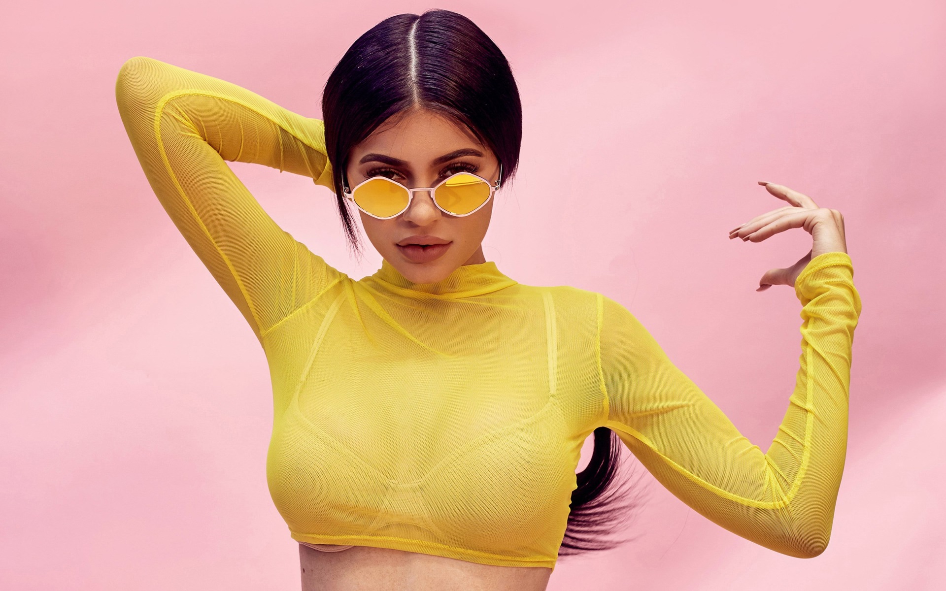 Kylie Jenner in yellow mesh top and sunglasses HD Wallpaper