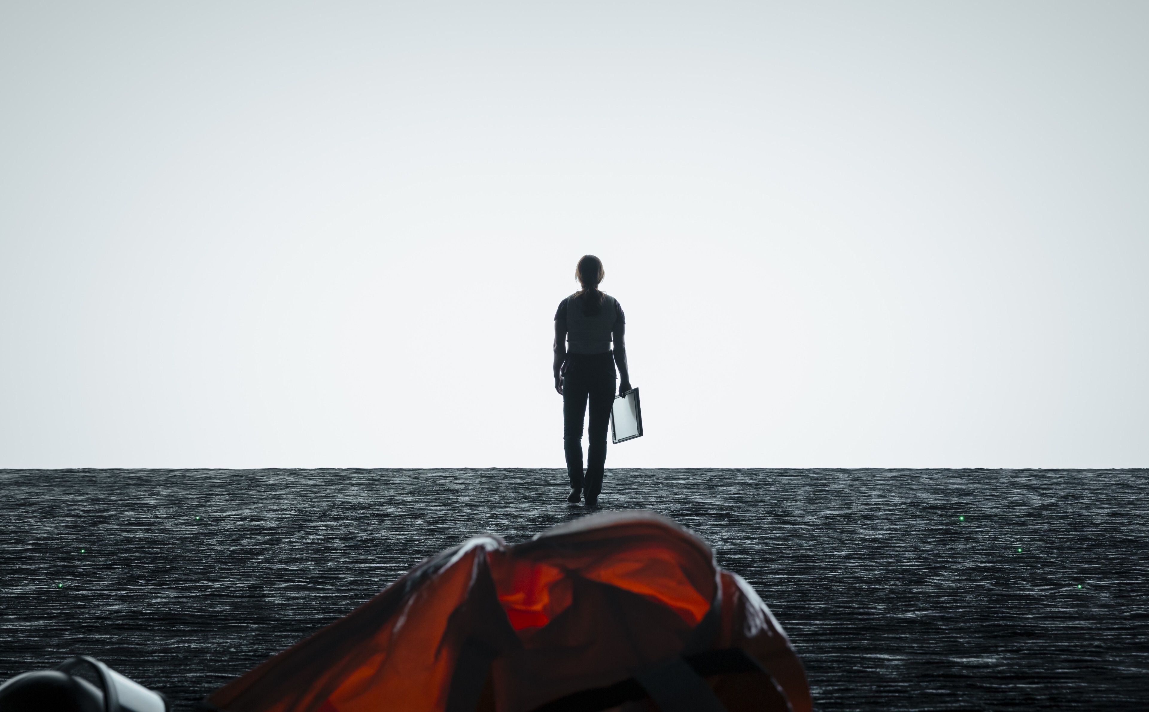 Person walking towards a bright light over water HD Wallpaper