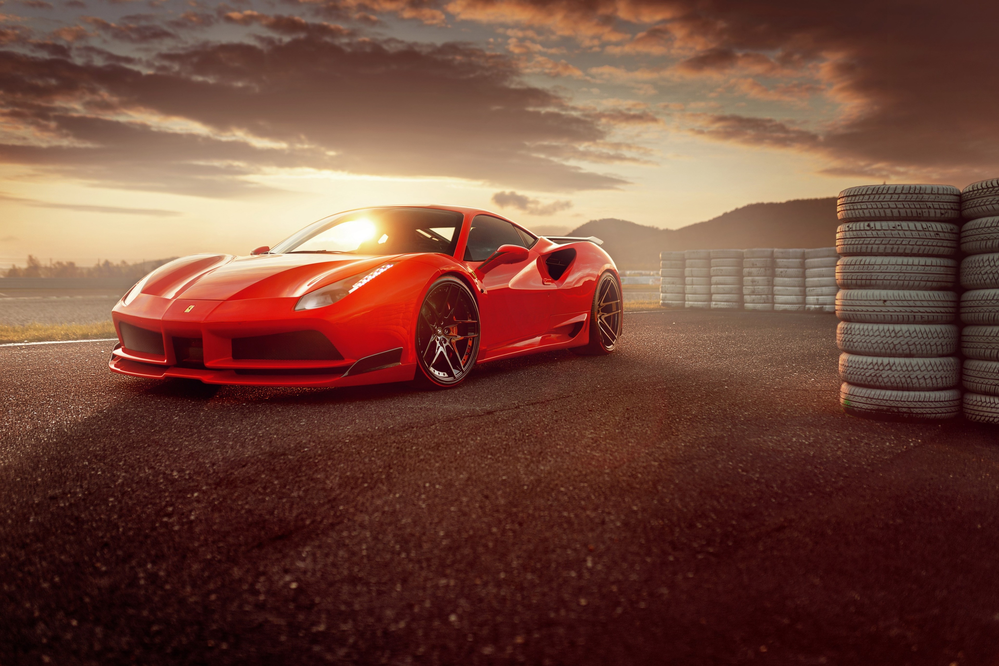 Red Ferrari 488 on a race track at sunset 4K HD Wallpaper