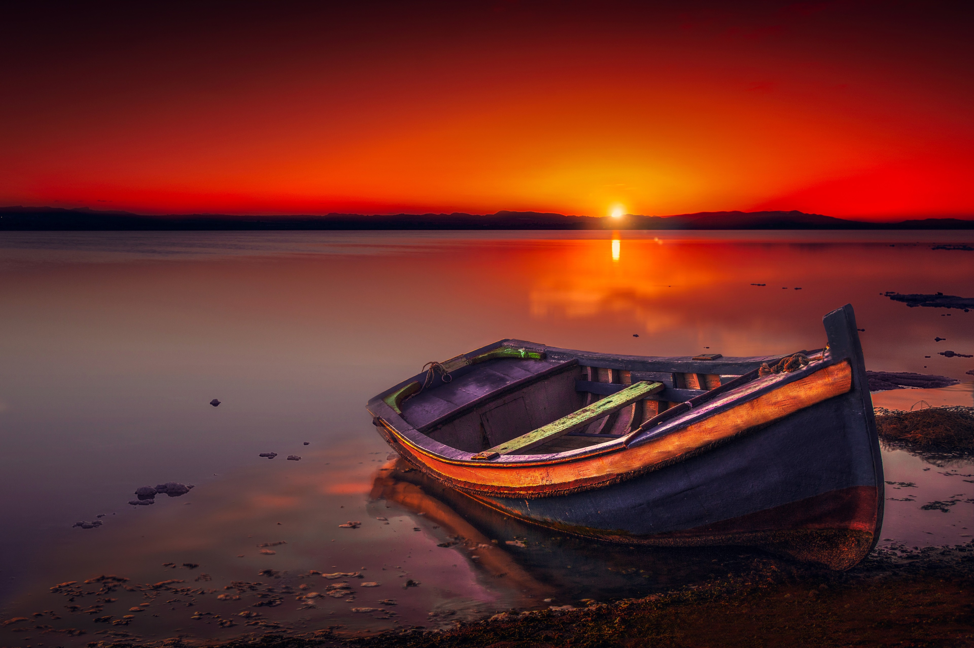 Boat on a lake at sunset 4K HD Wallpaper